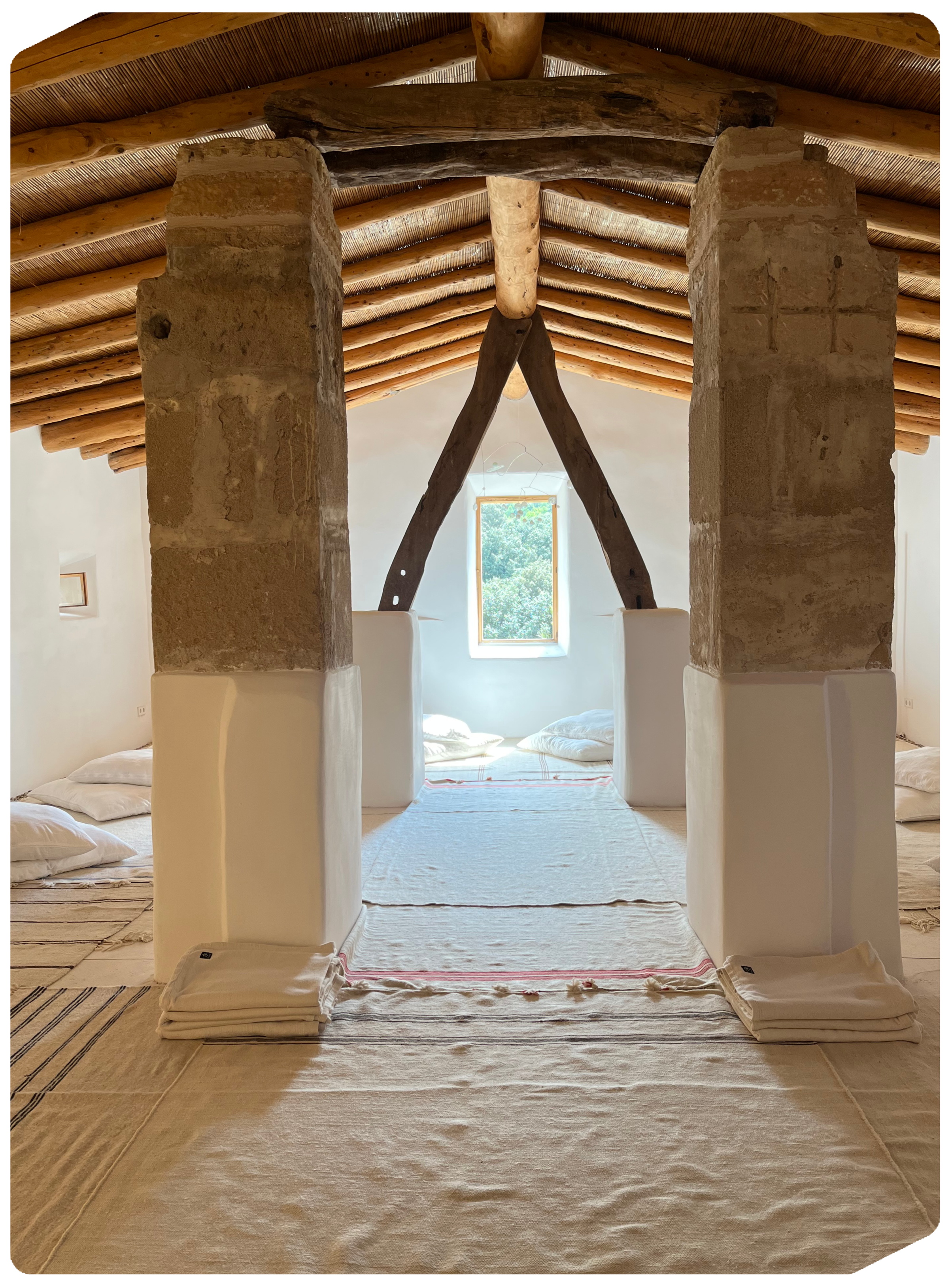 Luxury rustic suite with wooden beams at MED RESET Mallorca, designed for ultimate relaxation and wellness retreat guests.