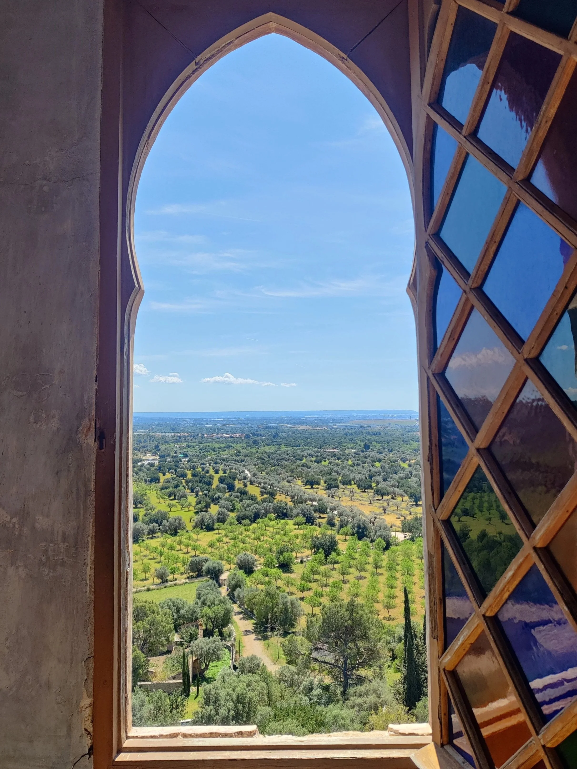 Open window view of the Serra de Tramuntana mountains and Mediterranean sea in Mallorca for a wellness retreat.