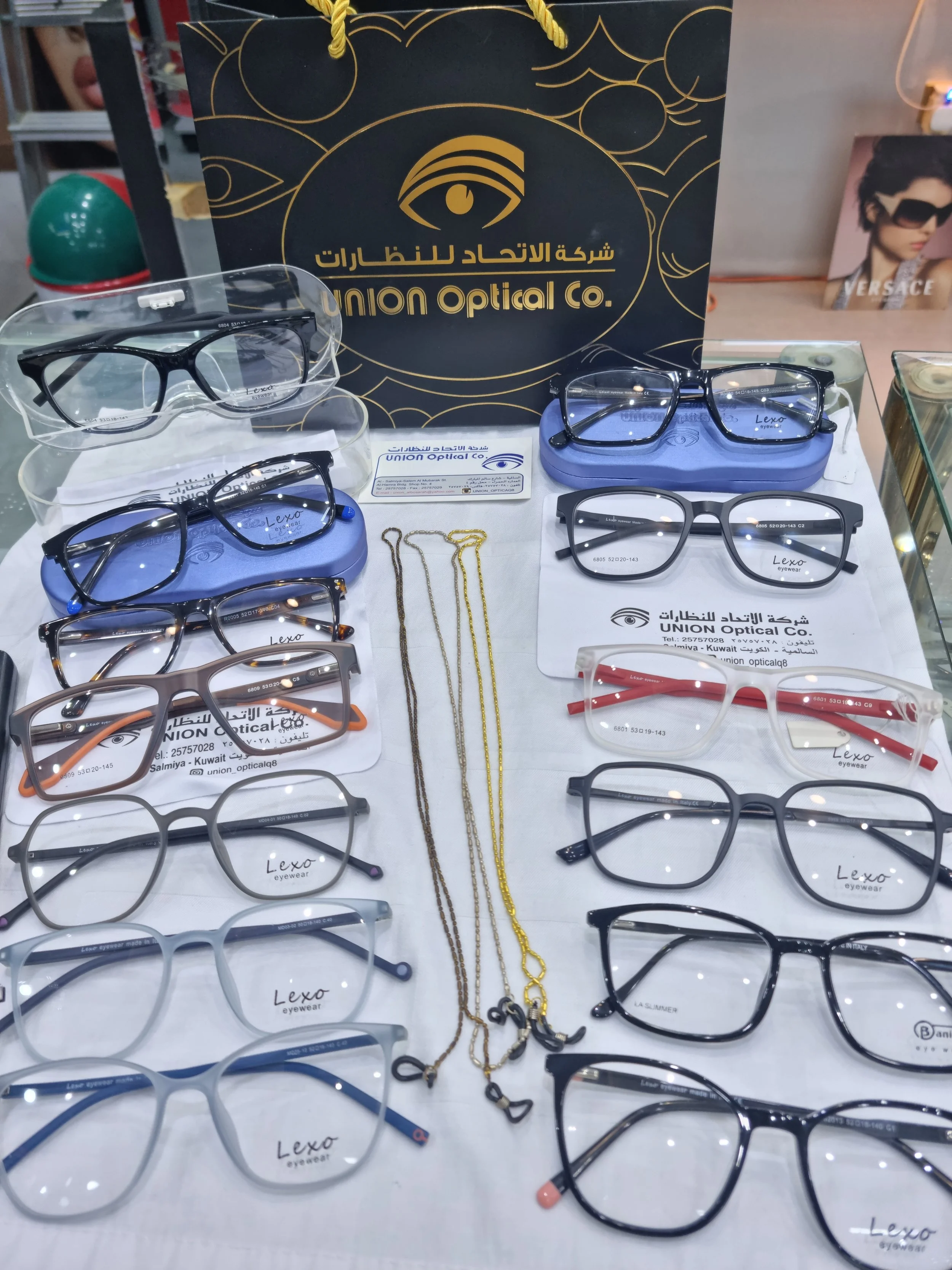 A display of various eyeglasses and sunglasses at Union Optical Co., including different styles, colors, and frames, with necklaces placed in the center.