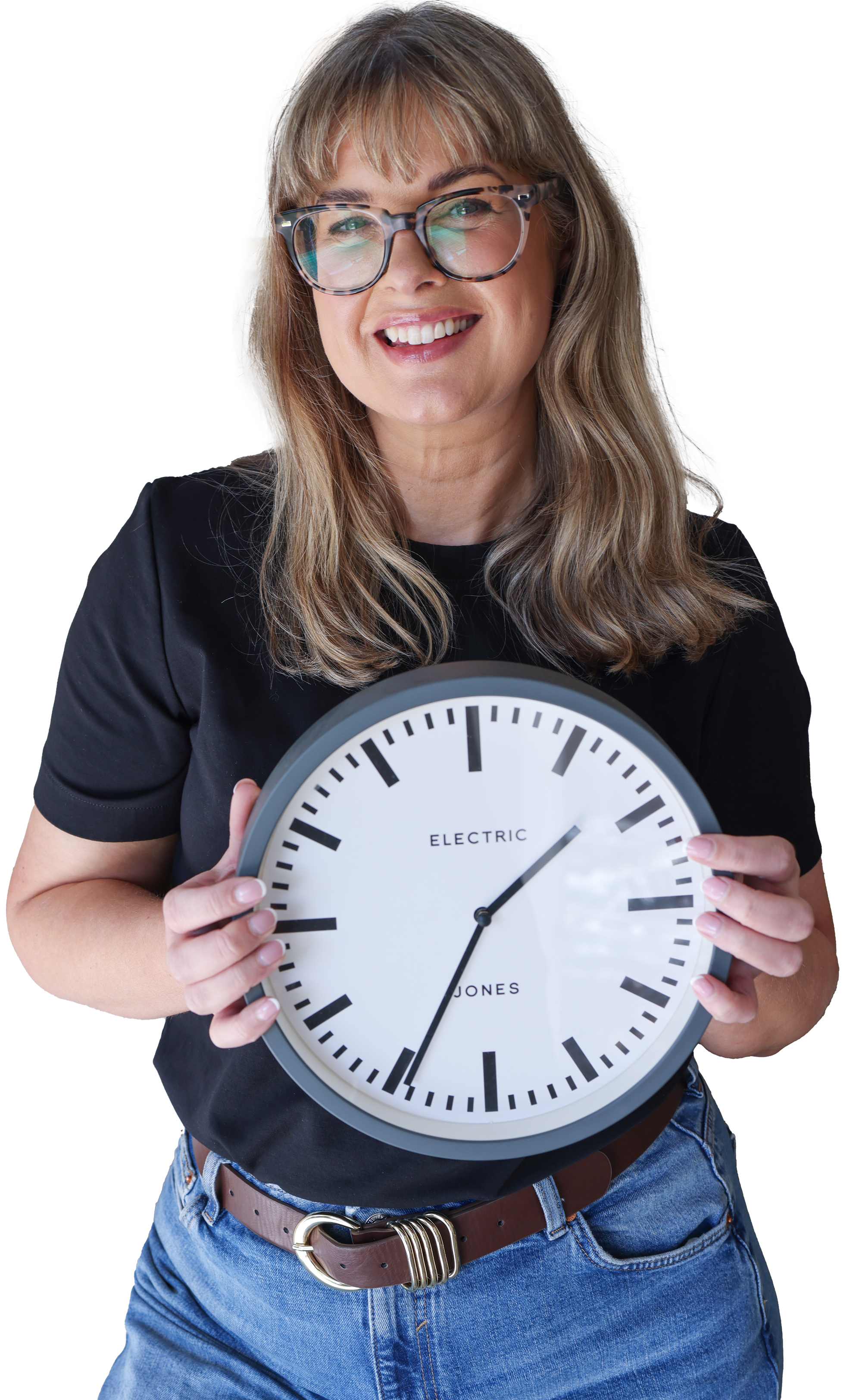 A woman smiling and wearing glasses, holding a large clock that reads approximately 1:39.