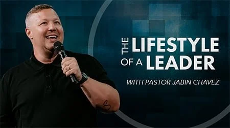 A man speaking into a microphone, with the text 'The Lifestyle of a Leader with Pastor Jabin Chavez' in the background.