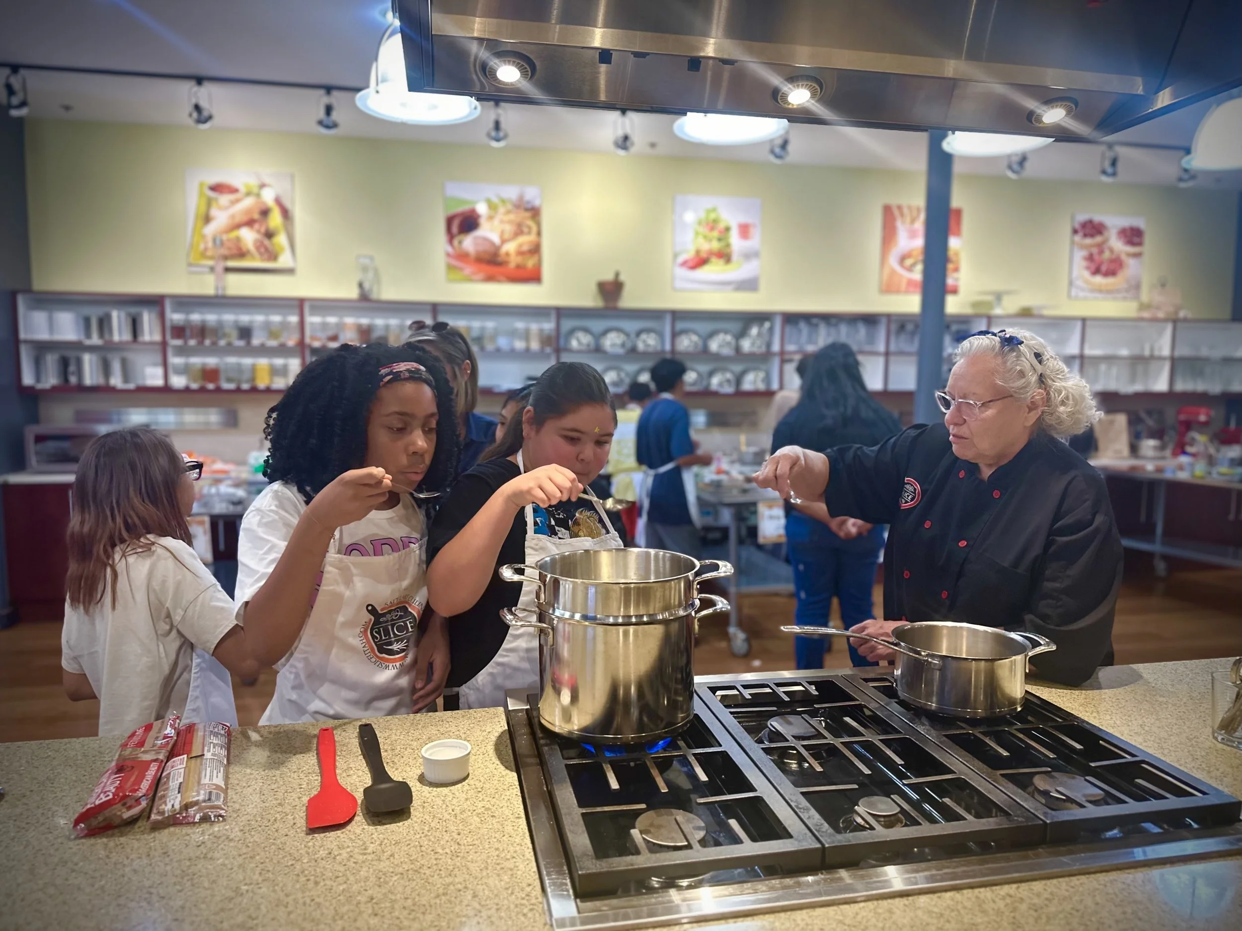 Kids in a cooking class with a mentor