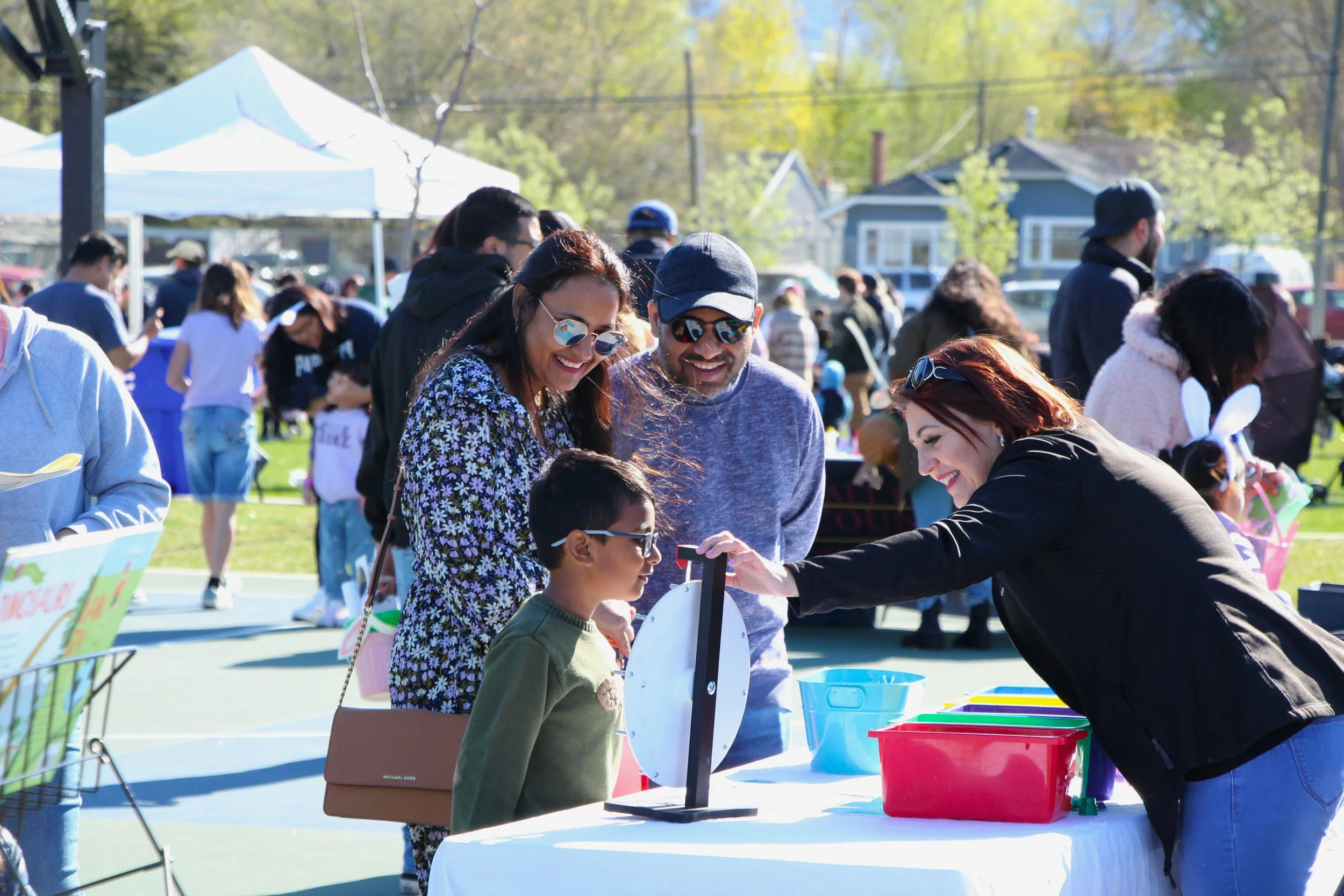 Family engaging at a booth during a community event
