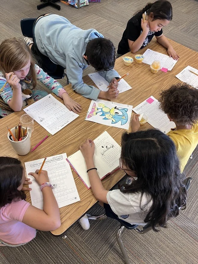 Kids completing worksheets.