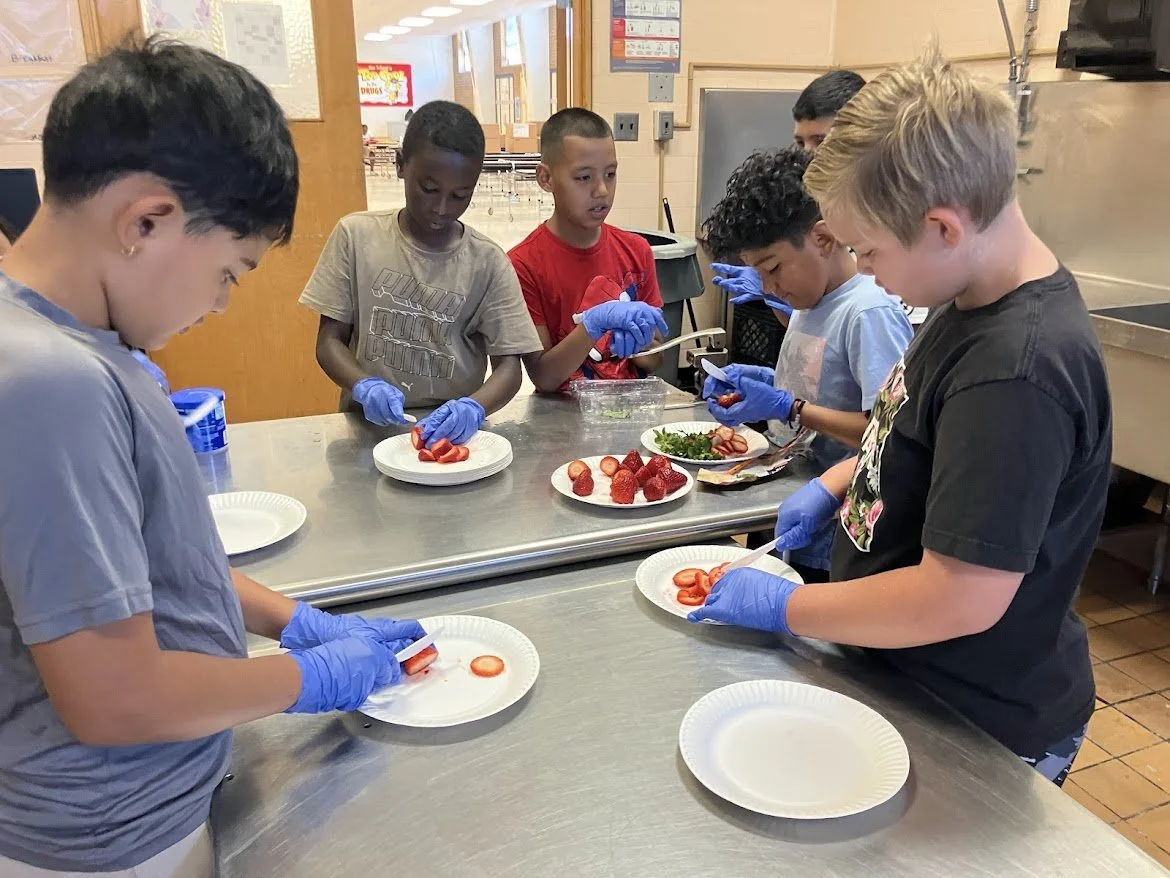 Kids slicing fruit