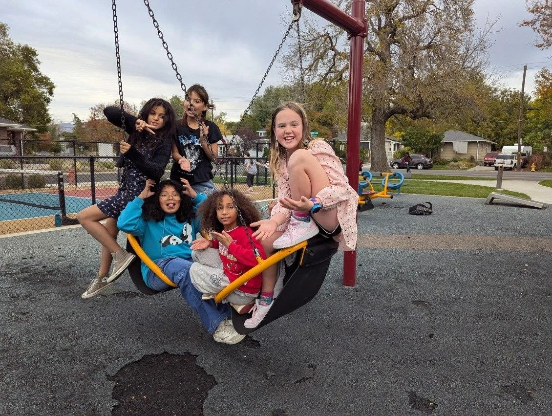 Kids on a swing in a playground
