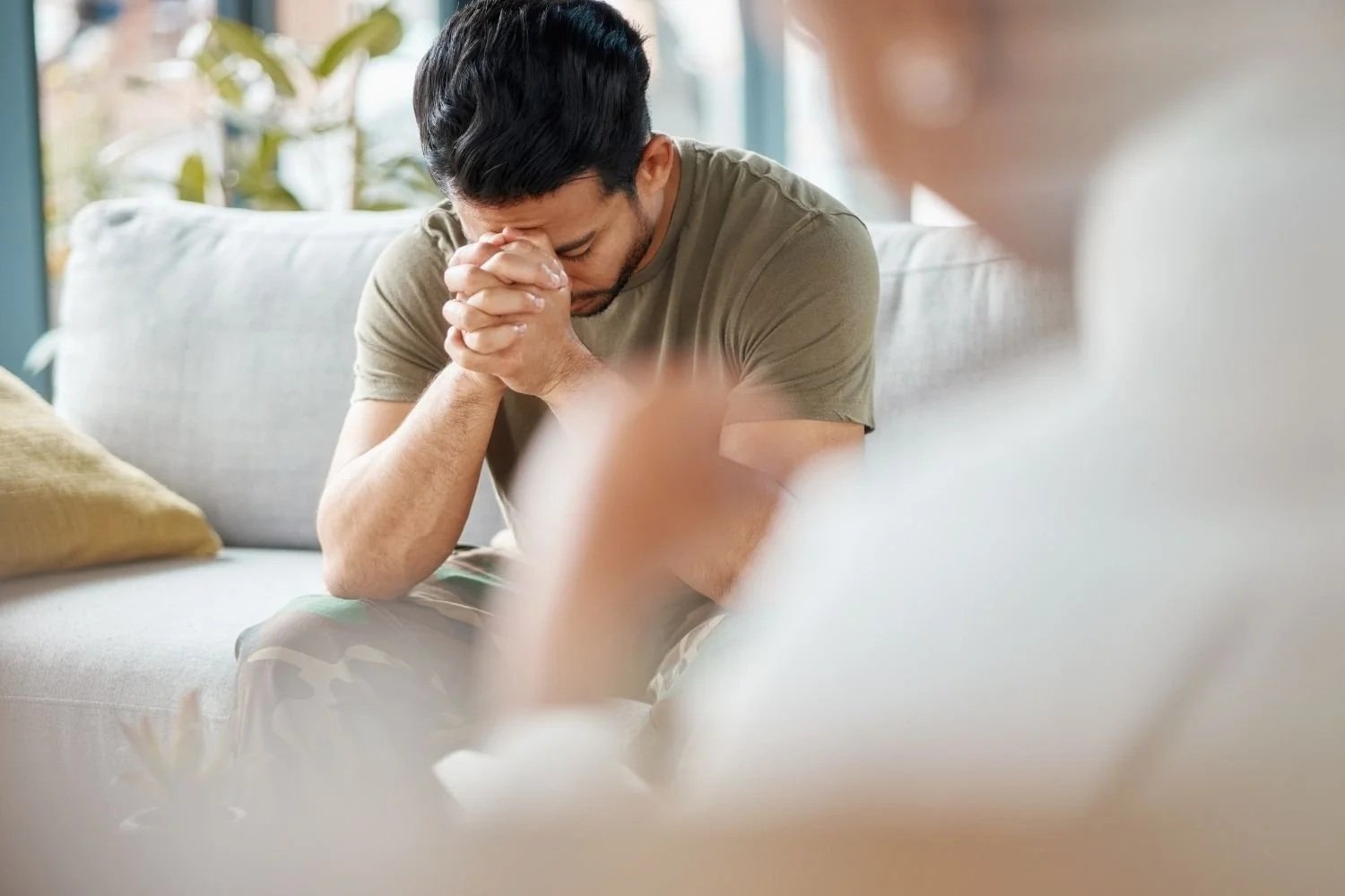 Man experiencing PTSD symptoms from trauma. In trauma therapy in Chicago. 