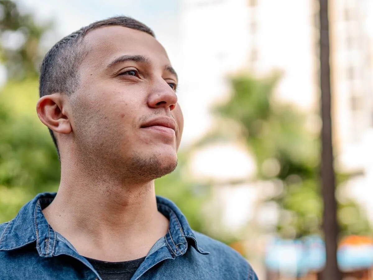 Person outdoors in deep thought representing inference-based cognitive behavioral therapy for OCD.