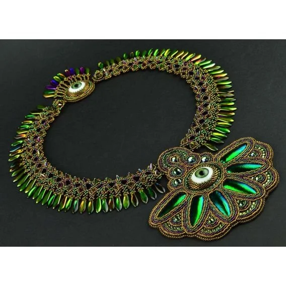Colorful beaded necklace with eye motifs and green feather-like accents on a black background.