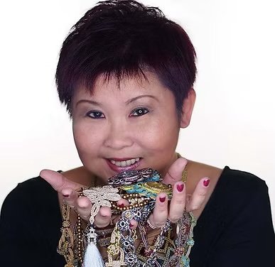 Woman smiling and holding jewelry or accessories