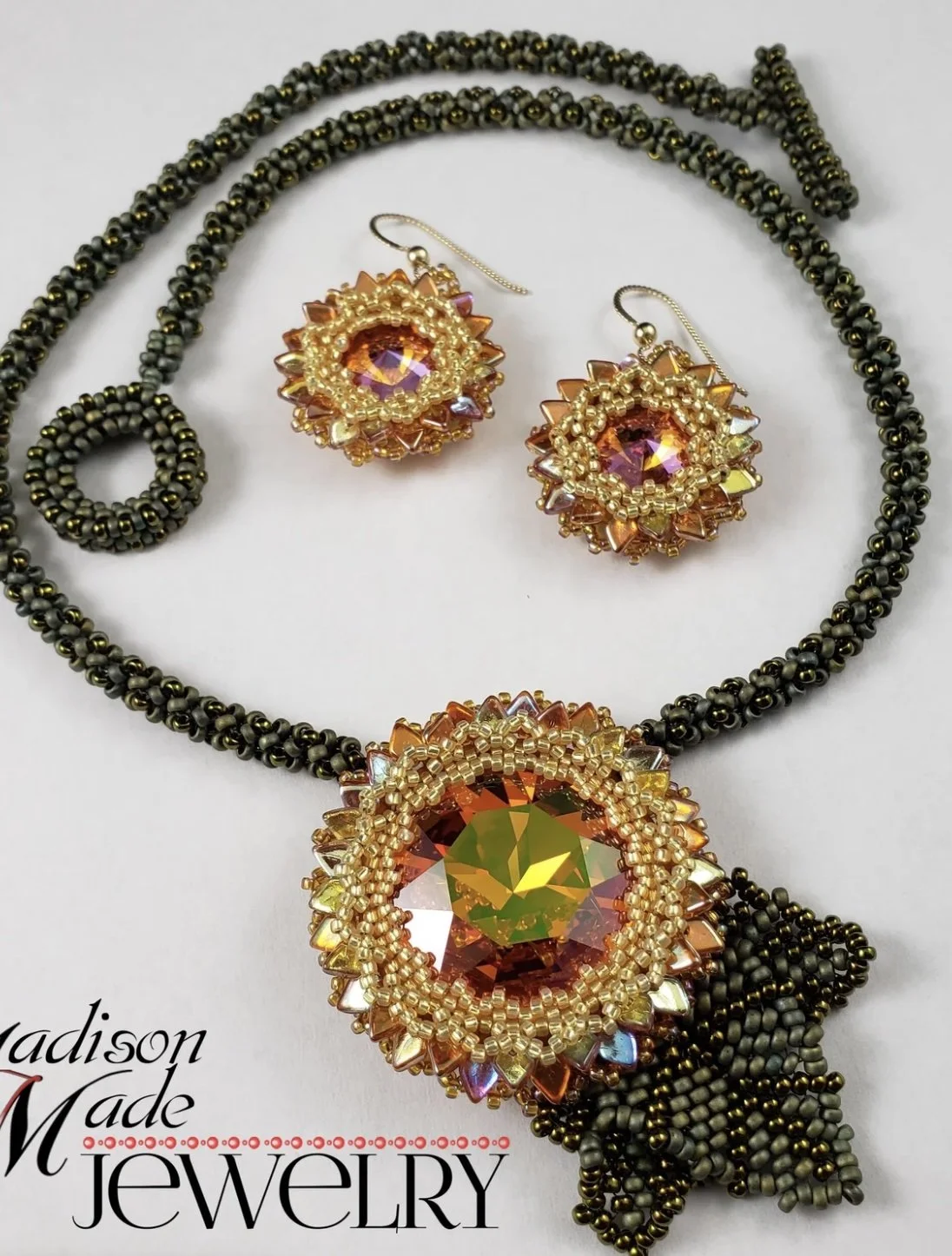 Beaded necklace with large orange and yellow gemstone pendant, matching orange and yellow gemstone earrings, all on a white background with 'Madison Made Jewelry' logo.