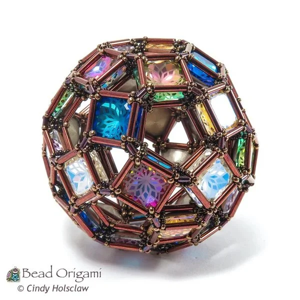 Colorful beaded origami sphere with intricate geometric design and iridescent beads.