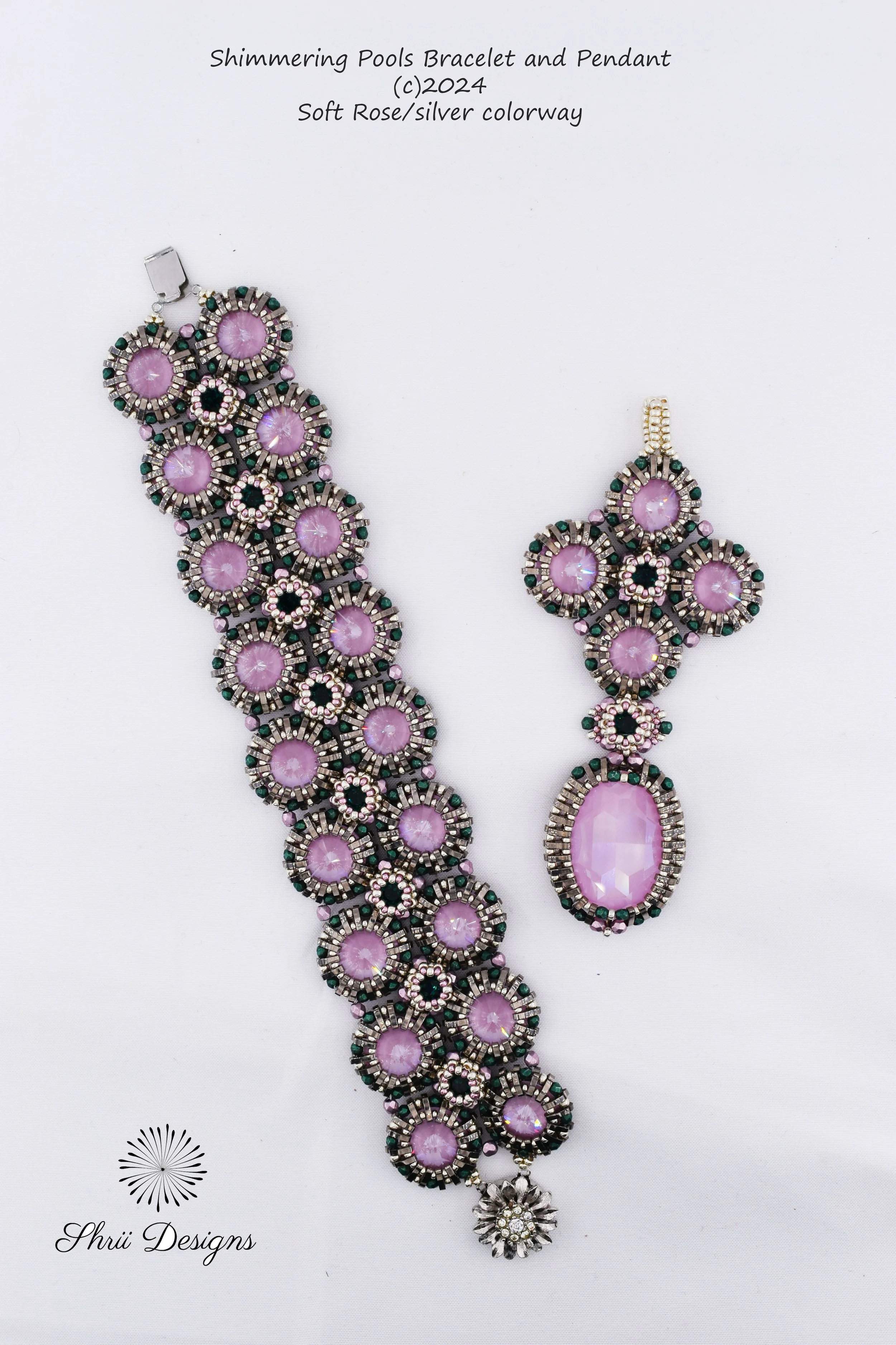 A jewelry display showing a matching bracelet and pendant set with pink and silver stones, designed by Shrii Designs. The set features intricate circular and floral patterns with rose, silver, and green accents.