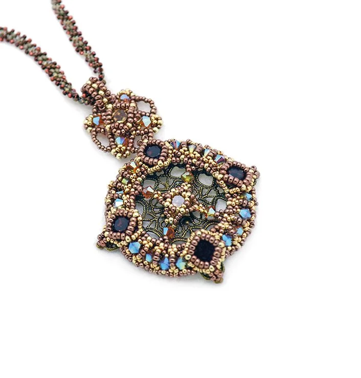 Intricate beaded necklace with a large square pendant featuring black and iridescent beads, set against a white background.