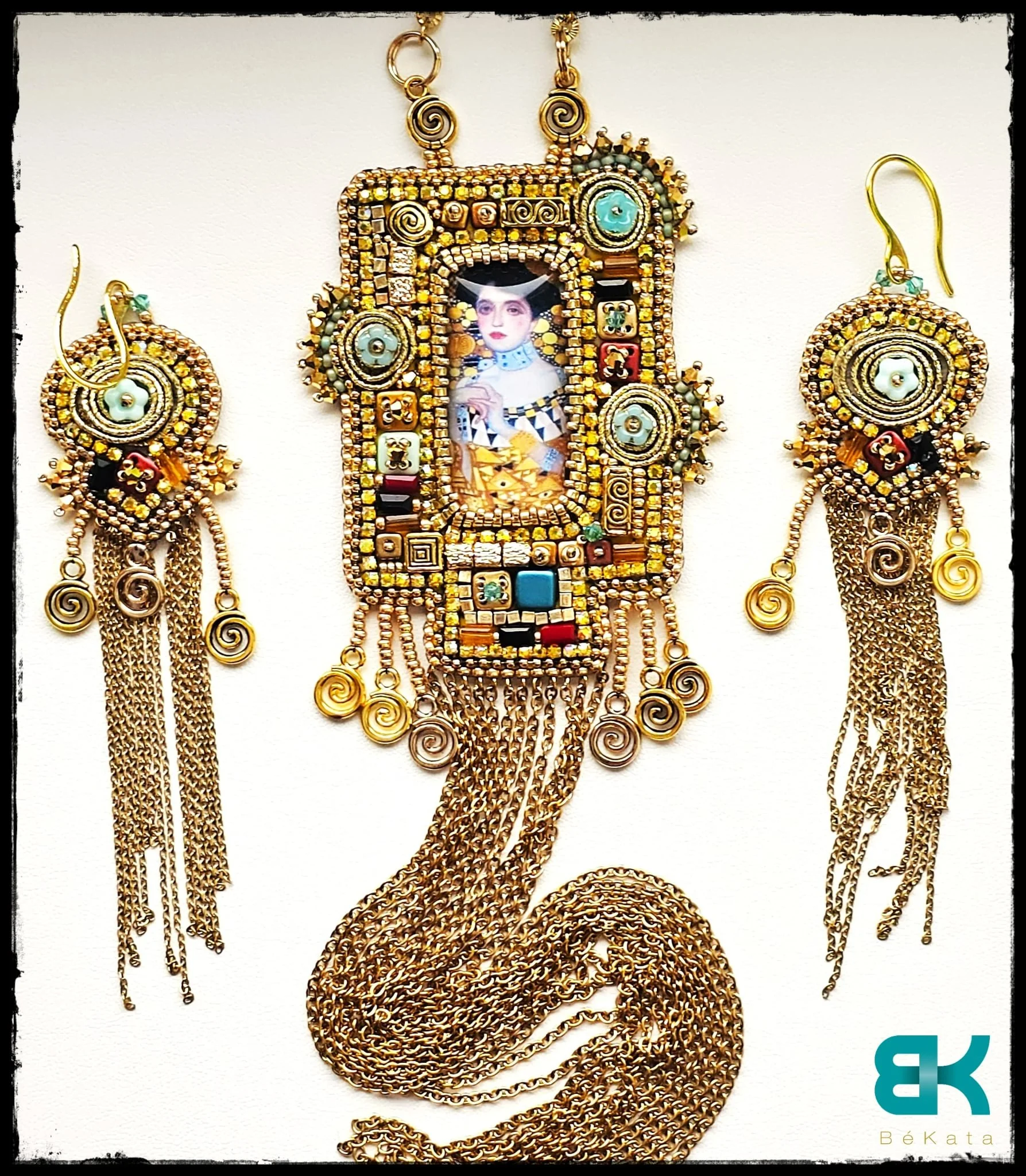 Jewelry set including a necklace and earrings with a mixed gold and colorful bead design, featuring a framed photograph of Frida Kahlo at the center, with gold chains and decorative spirals.