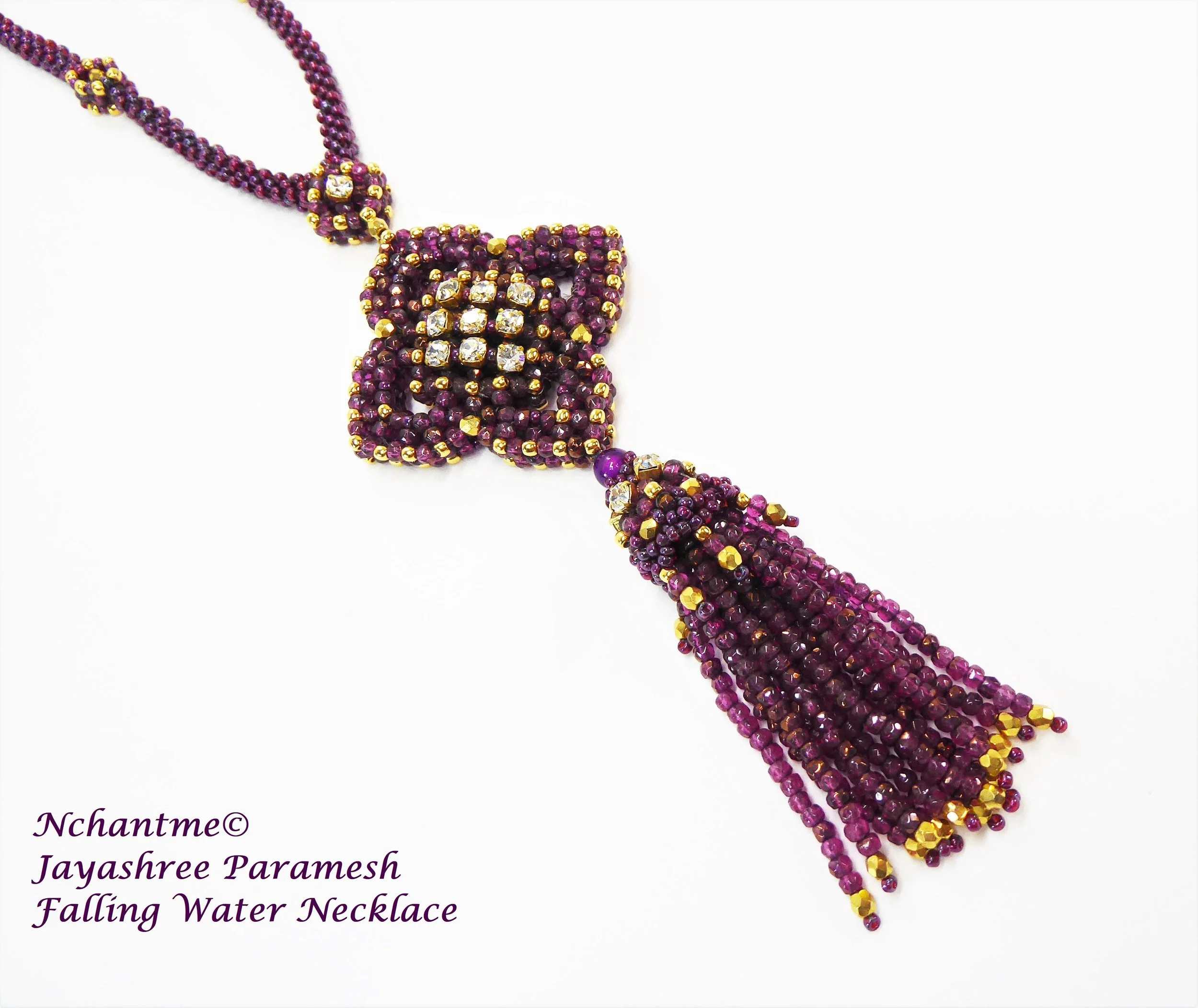 Colorful beaded necklace with a cluster pendant and a dropped water design, predominantly in shades of purple, gold, and clear stones.