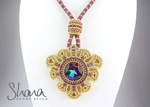 A gold and pink beaded necklace with a large, ornate pendant featuring a dark purple gemstone surrounded by gold beaded loops and smaller pink beads.