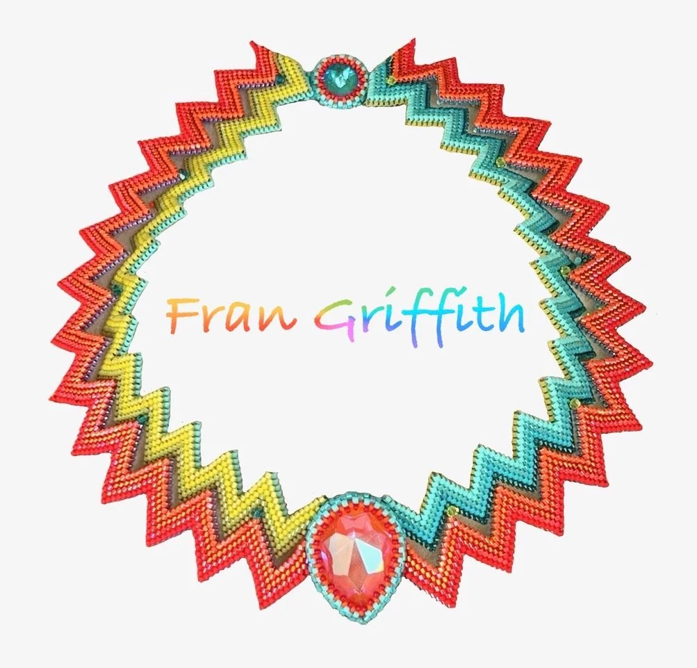 Colorful bead necklace with zigzag pattern and large gem in the center, with the name 'Fran Griffith' written in rainbow colors in the middle.