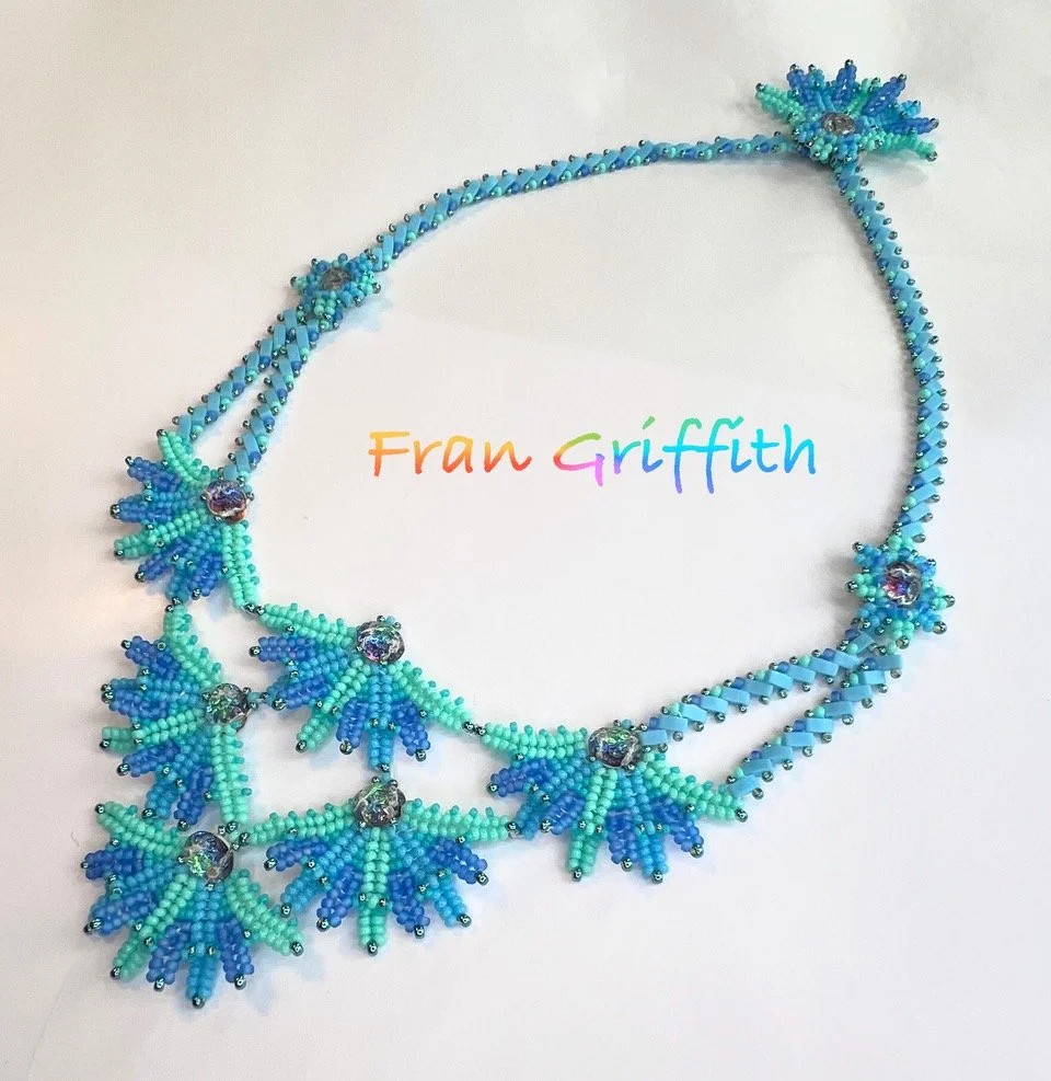 Beaded necklace with blue and green bead clusters and rhinestone accents, with the name 'Fran Griffith' written in multi-colored text.