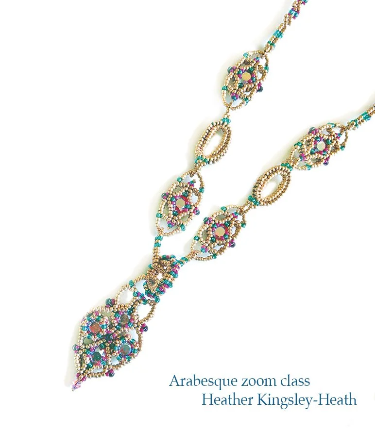 A colorful beaded necklace with intricate patterns on a white background, featuring shades of blue, pink, purple, and gold.