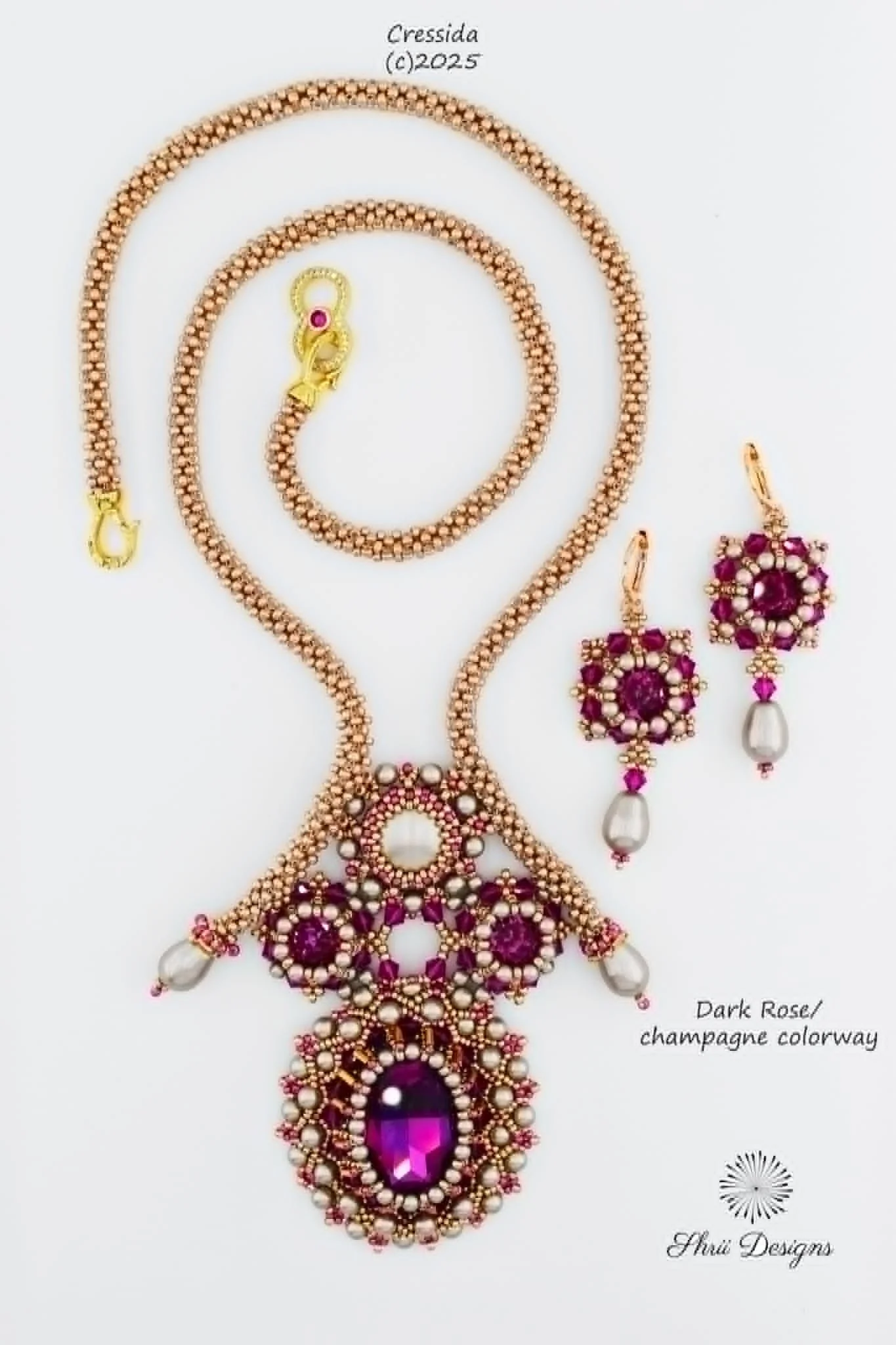 A detailed jewelry set including a necklace and matching earrings in a dark rose champagne colorway, with pearls and purple gemstones, displayed against a white background. The text at the top shows the designer's name, Cressida, and copyright date, 