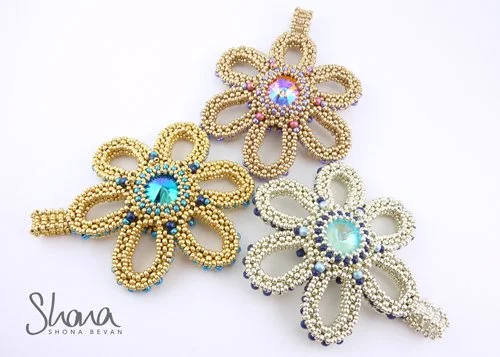 Three beaded flower-shaped pendants with rhinestones, in gold, pink, and silver colors, on a white background.