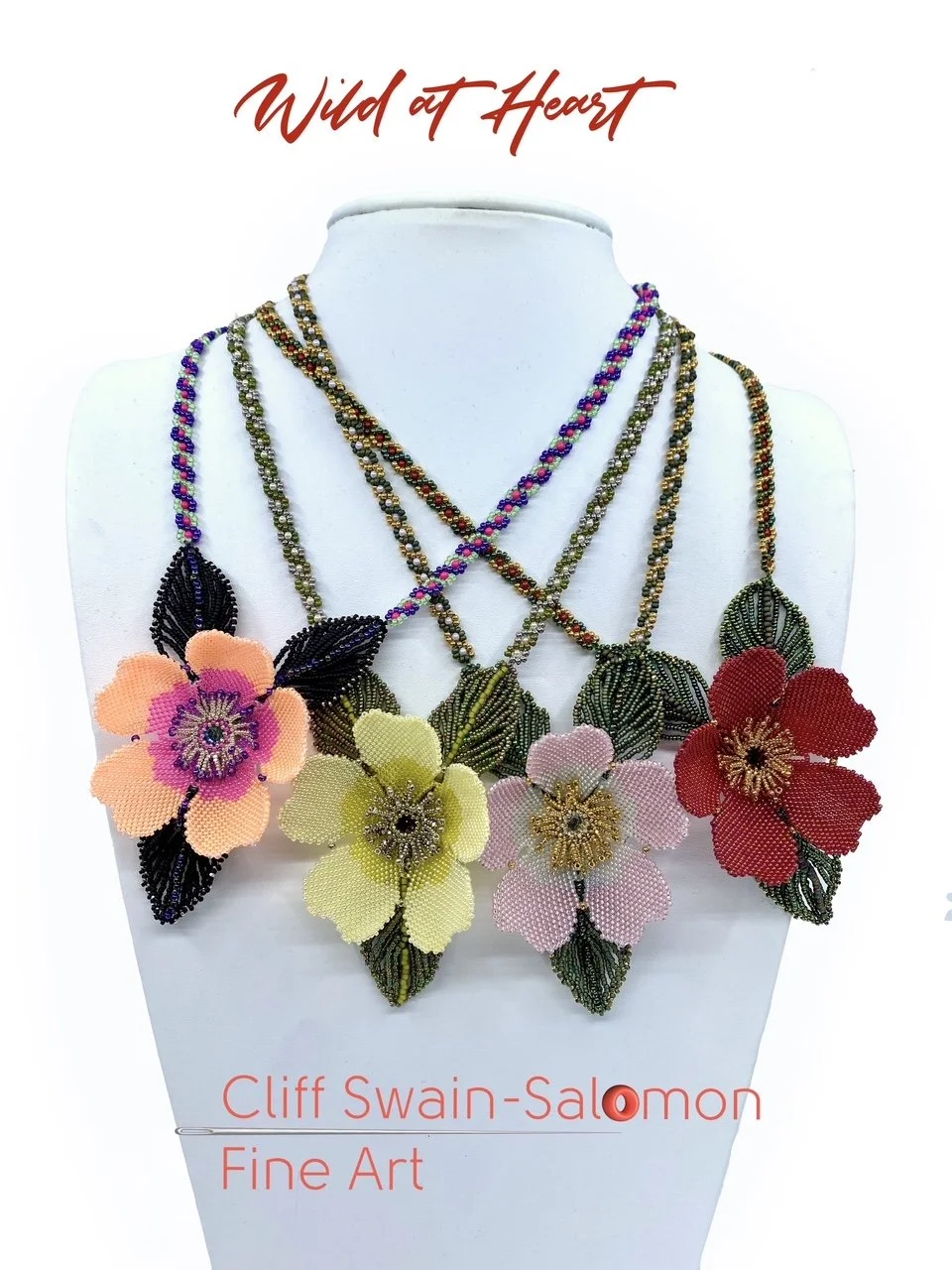 Display of colorful beaded floral necklaces with large flower pendants on a white bust. The text "Wild at Heart" and the artist's name, "Cliff Swain-Salomon Fine Art," are written above and below the jewelry.