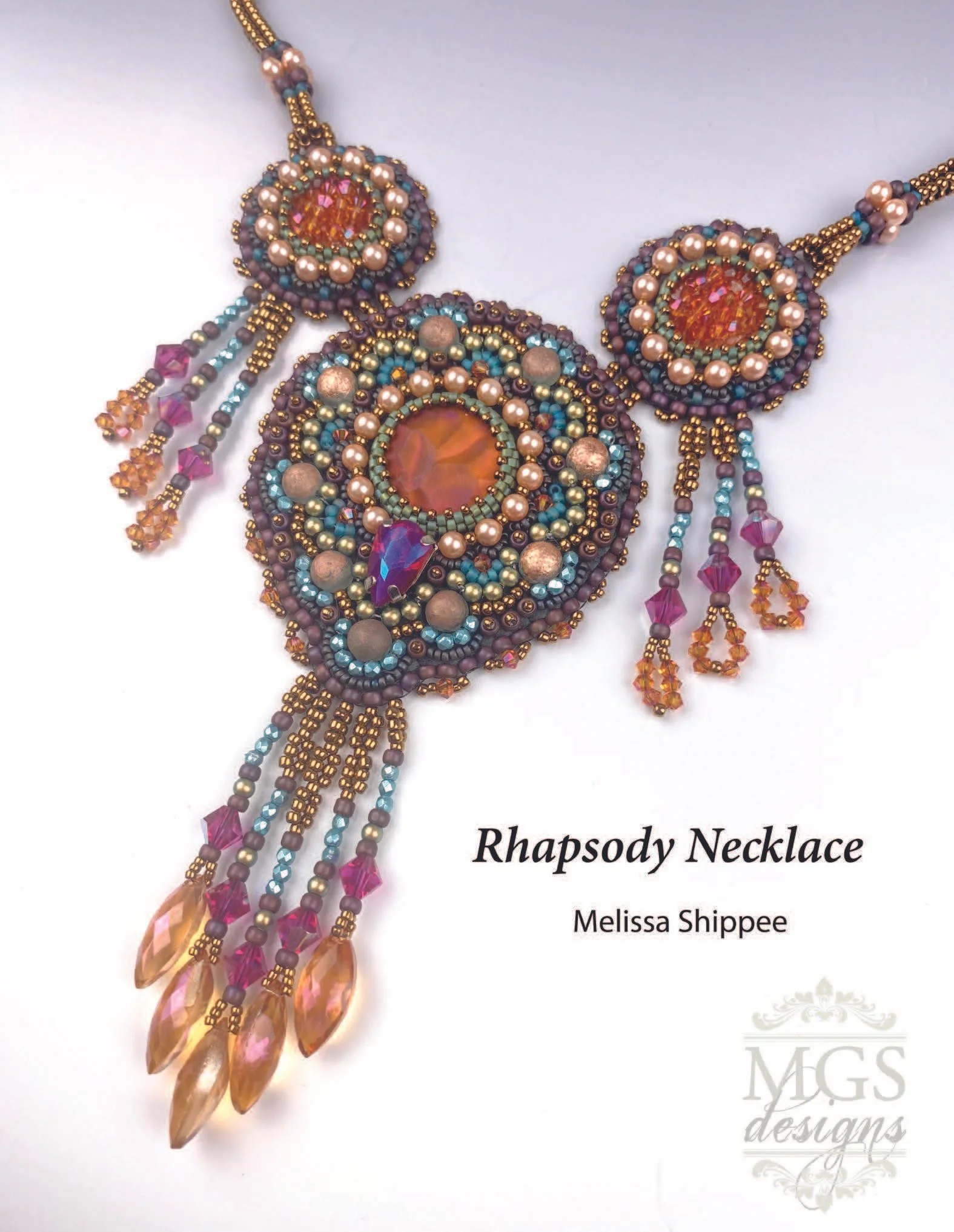 Ornate beaded necklace called Rhapsody Necklace with pink, blue, purple, and amber beads, featuring large teardrop-shaped amber beads and a central circular pendant, on white background with text indicating it is designed by Melissa Shippee for MGS L