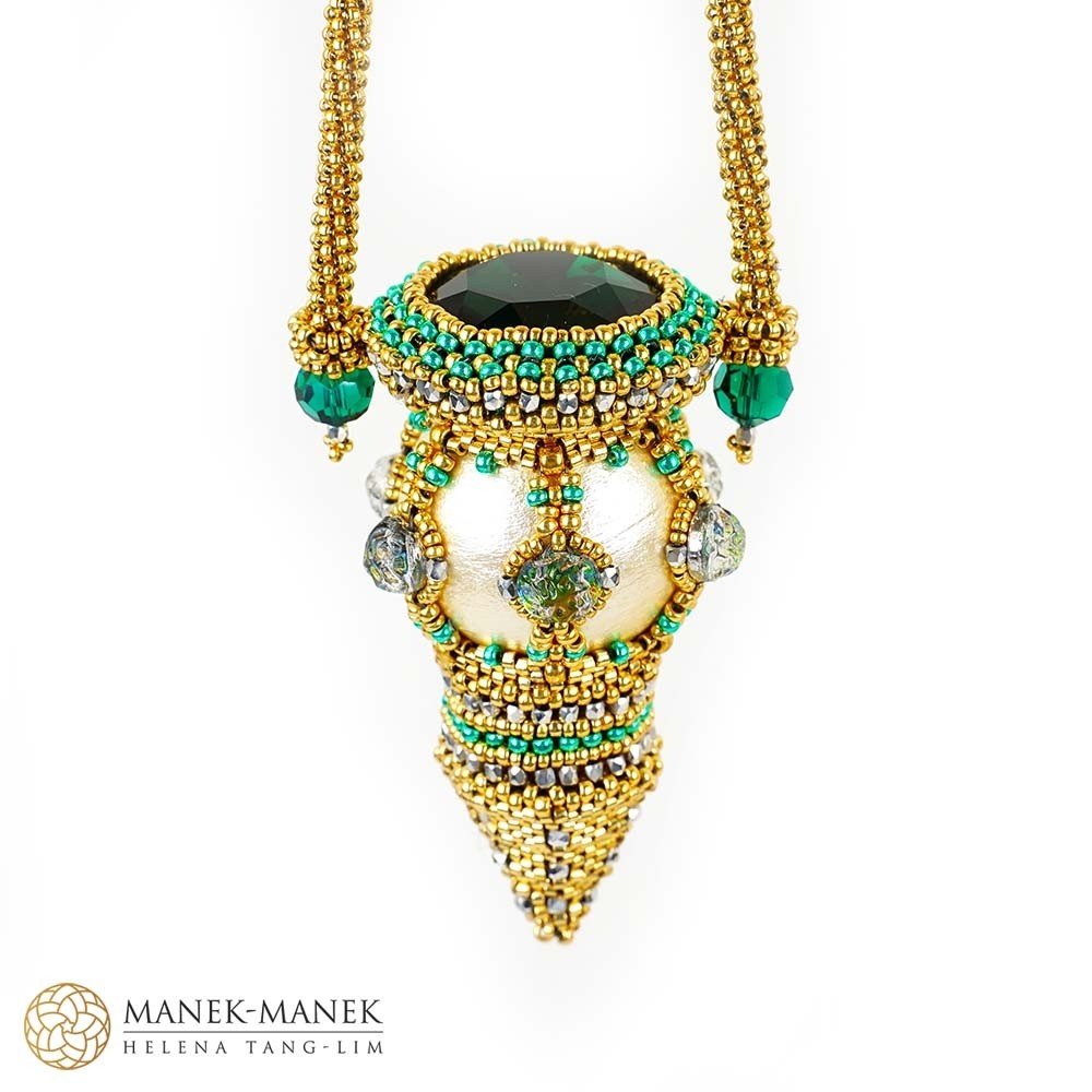 Jewelry pendant with gold beads, green and silver accents, and a large dark green stone at the top, with a necklace string attached.