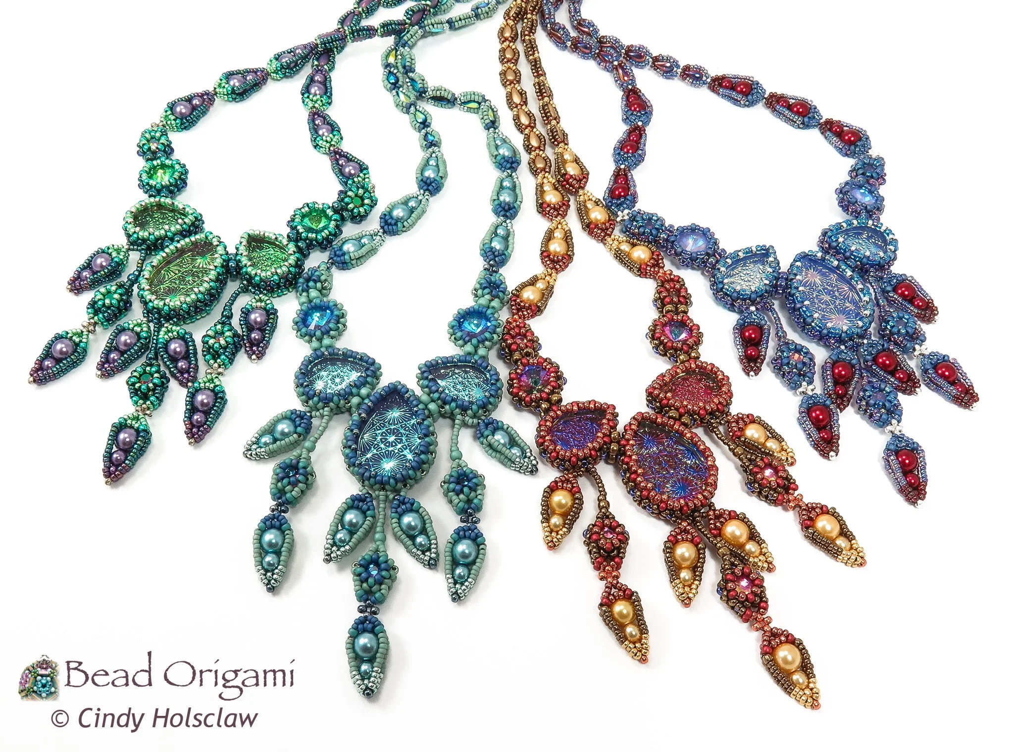 Colorful beaded necklaces with beaded leaf and flower designs, arranged in a layered fashion on a white background.