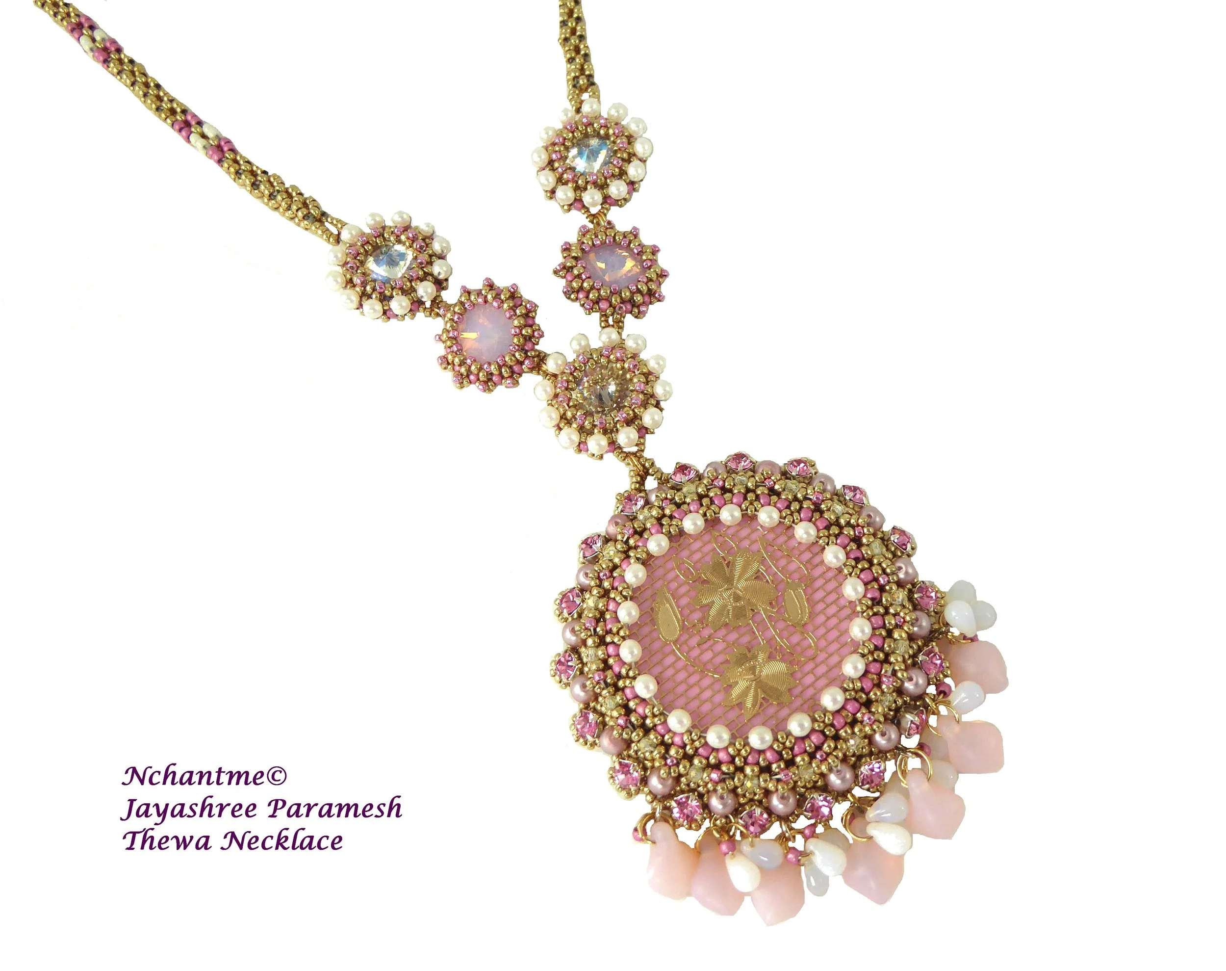 A colorful beaded necklace with pearls and pink accents, featuring large central stones, gold detailing, and decorative elements on a white background.