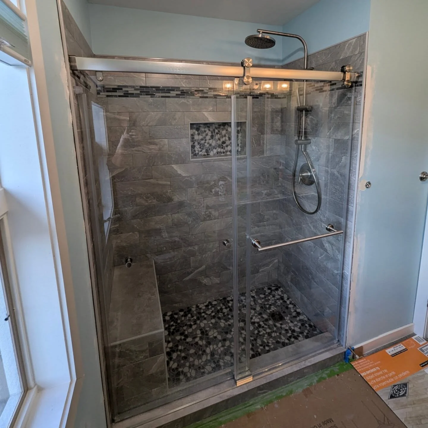 A walk in shower conversion we did for some family friends. They had a standard fiberglass bathtub and surround and wanted to upgrade. Highlights include recycled glass pebbles for the floor and niche, a full bench, and a dual head rain head fixture 