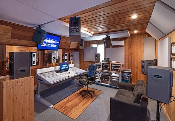 Side view of SpectraSound LLC control room showing immersive Dolby Atmos audio mixing and surround sound setup for post‑production