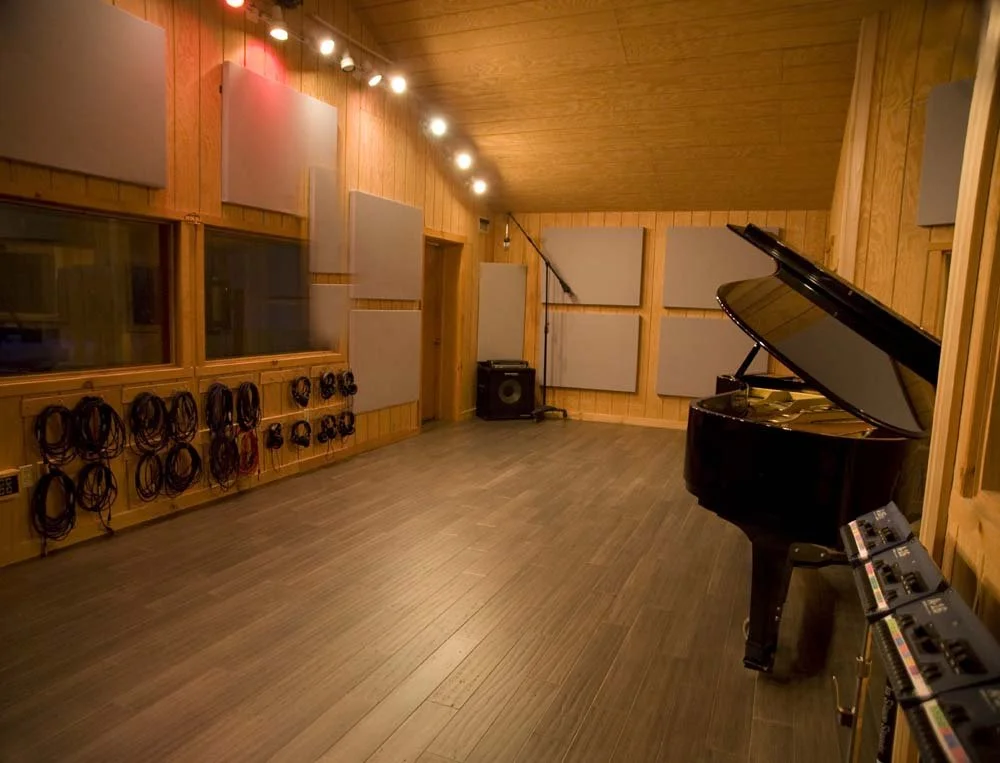 Recording session with musicians and premium audio equipment at professional recording studio