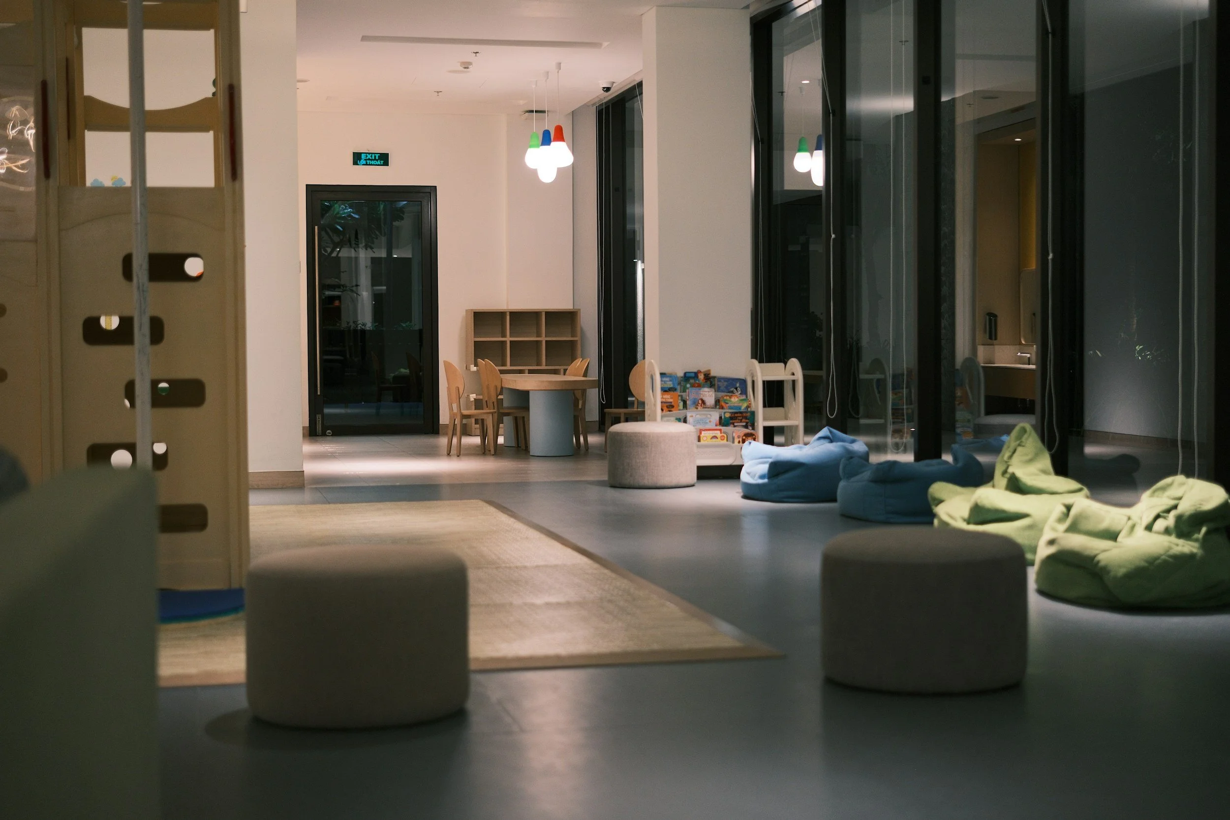 Sensory room designed for children with additional needs, featuring calm lighting, soft furnishings, and open space for learning and support
