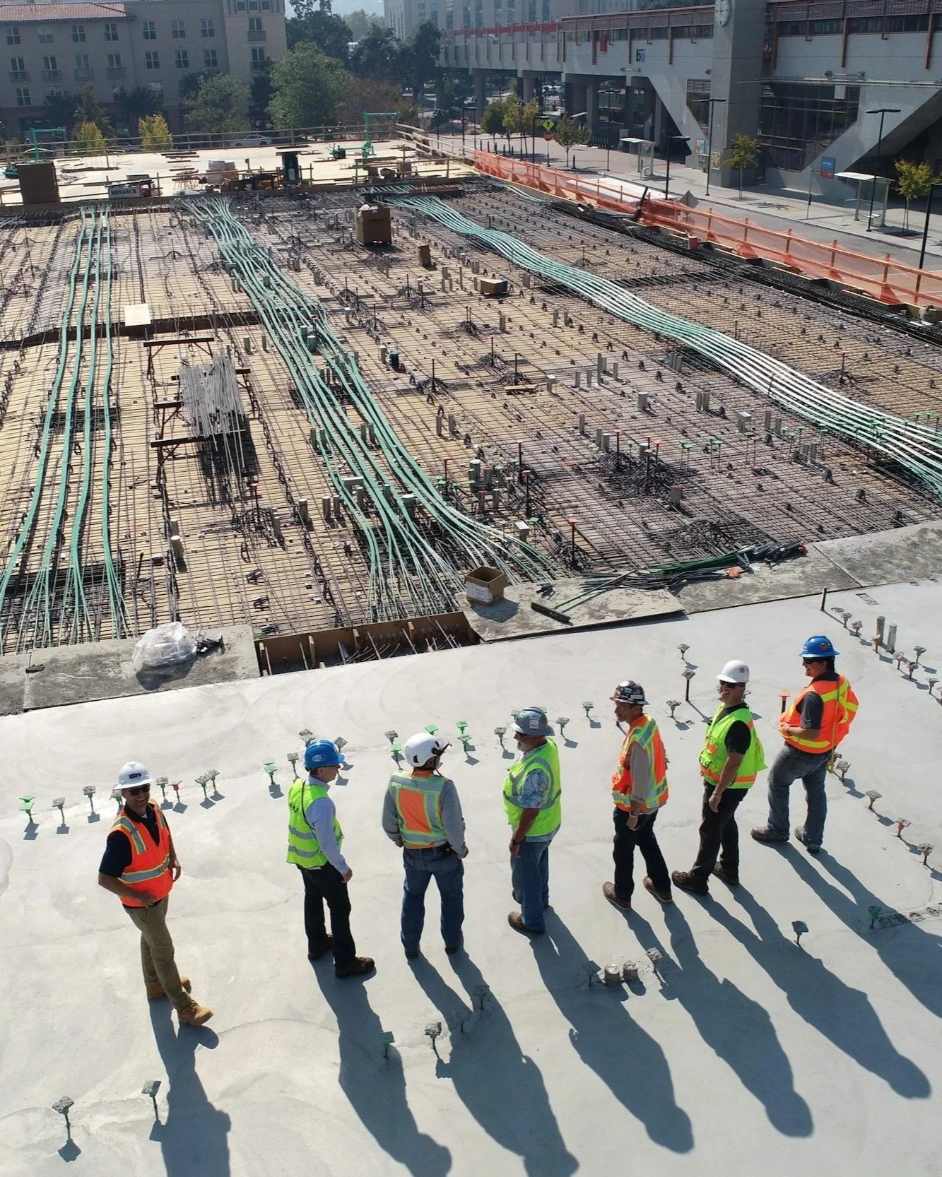 Construction team on site reviewing groundwork and layout on an active build.