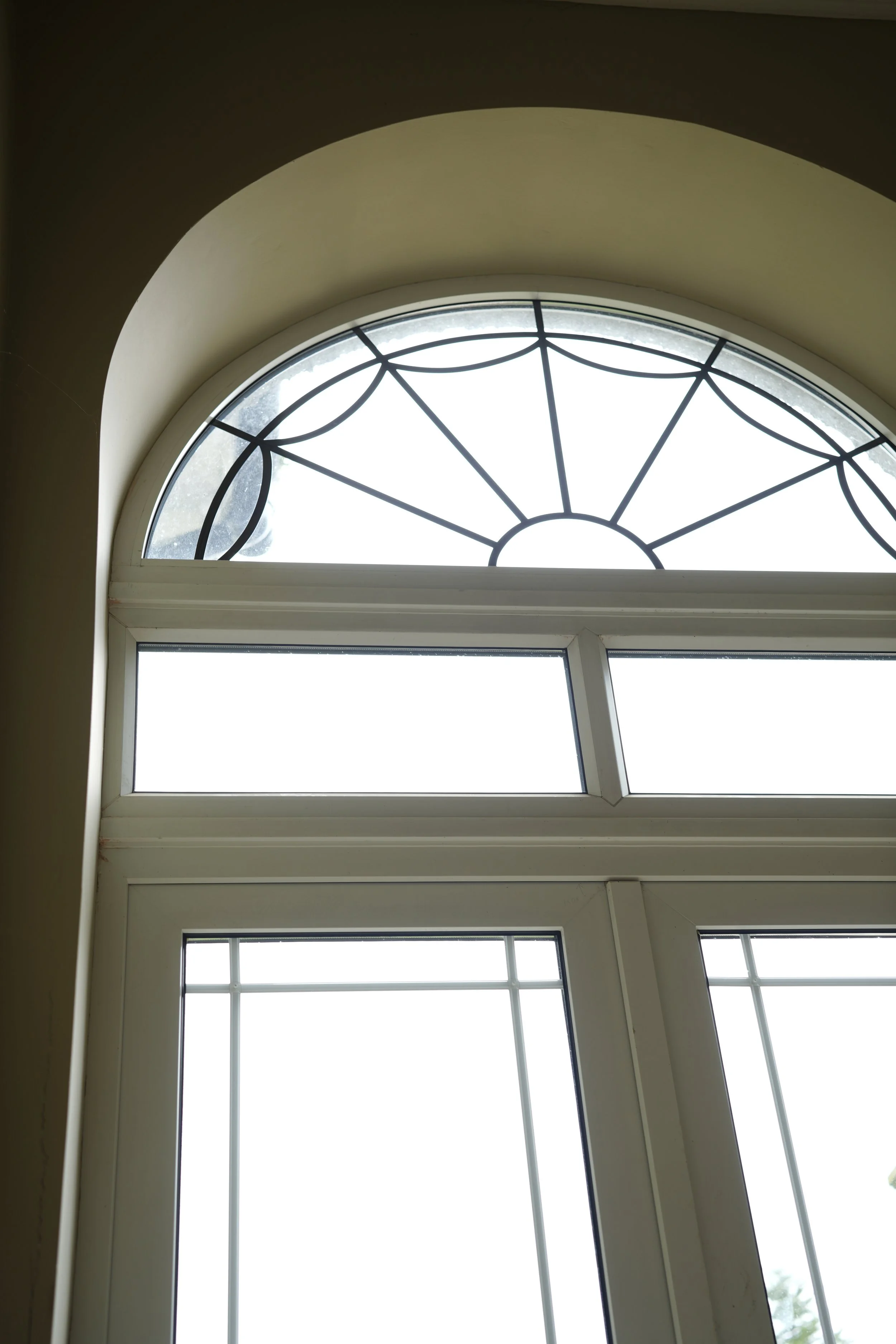Large arched window on first floor