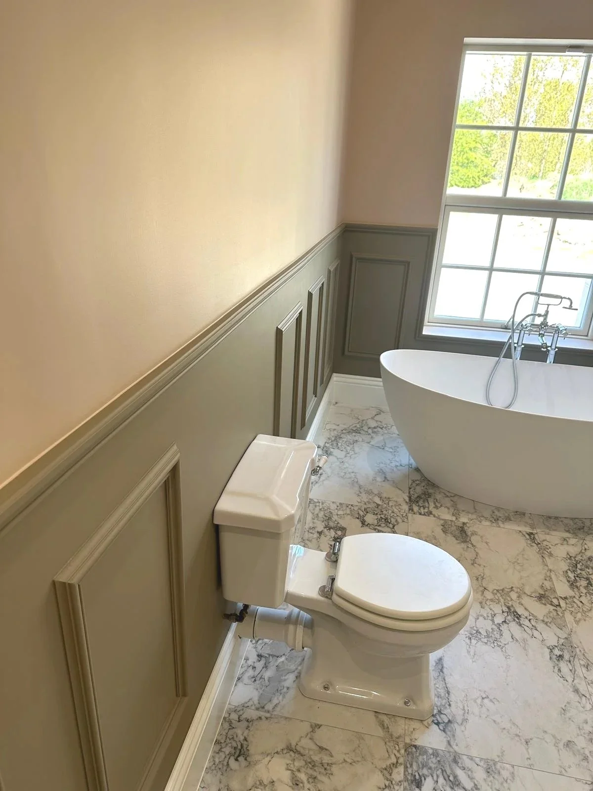 New build bungalow in Tipperary with panelled walls, freestanding bath and marble flooring.