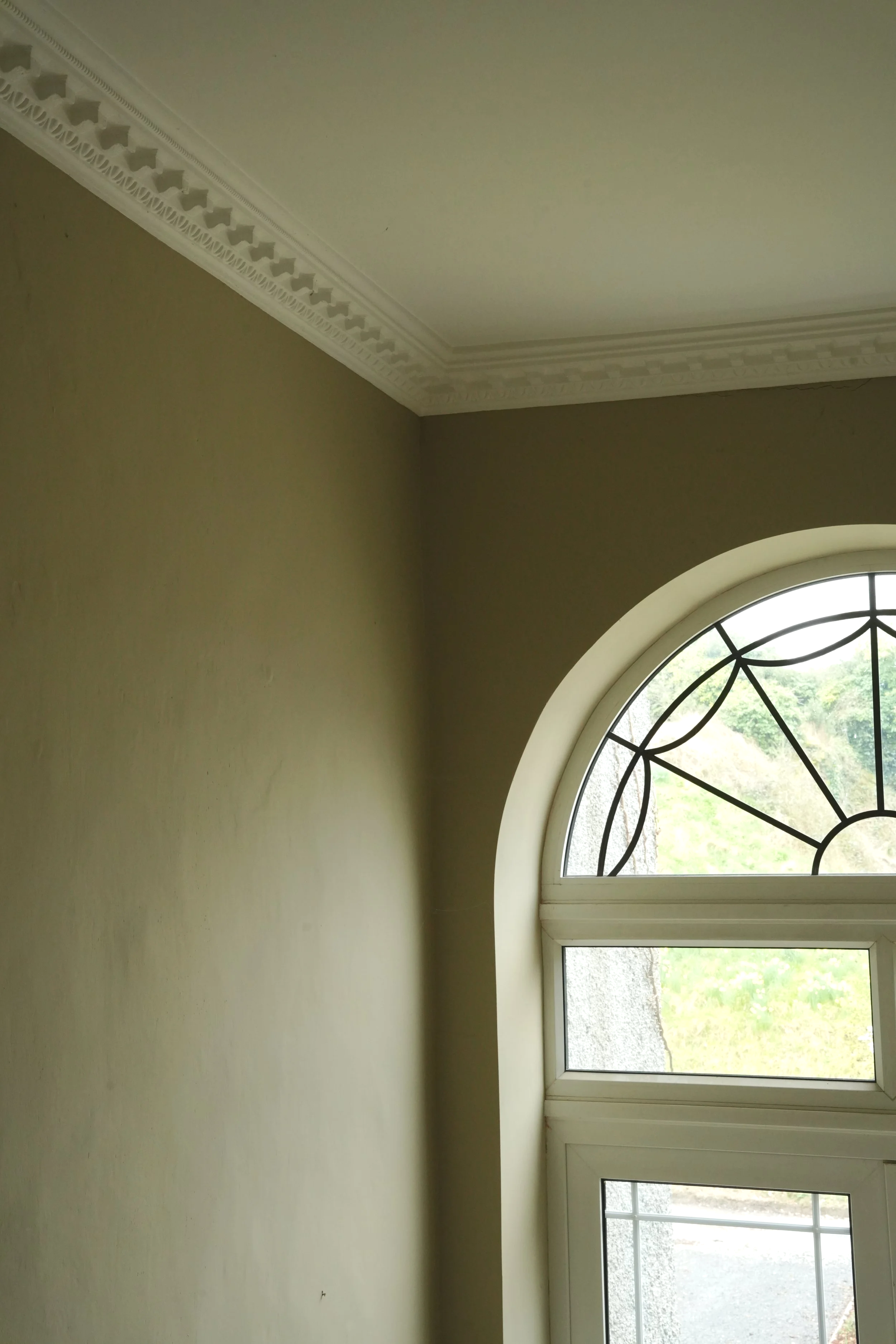 An arched window and cornice details