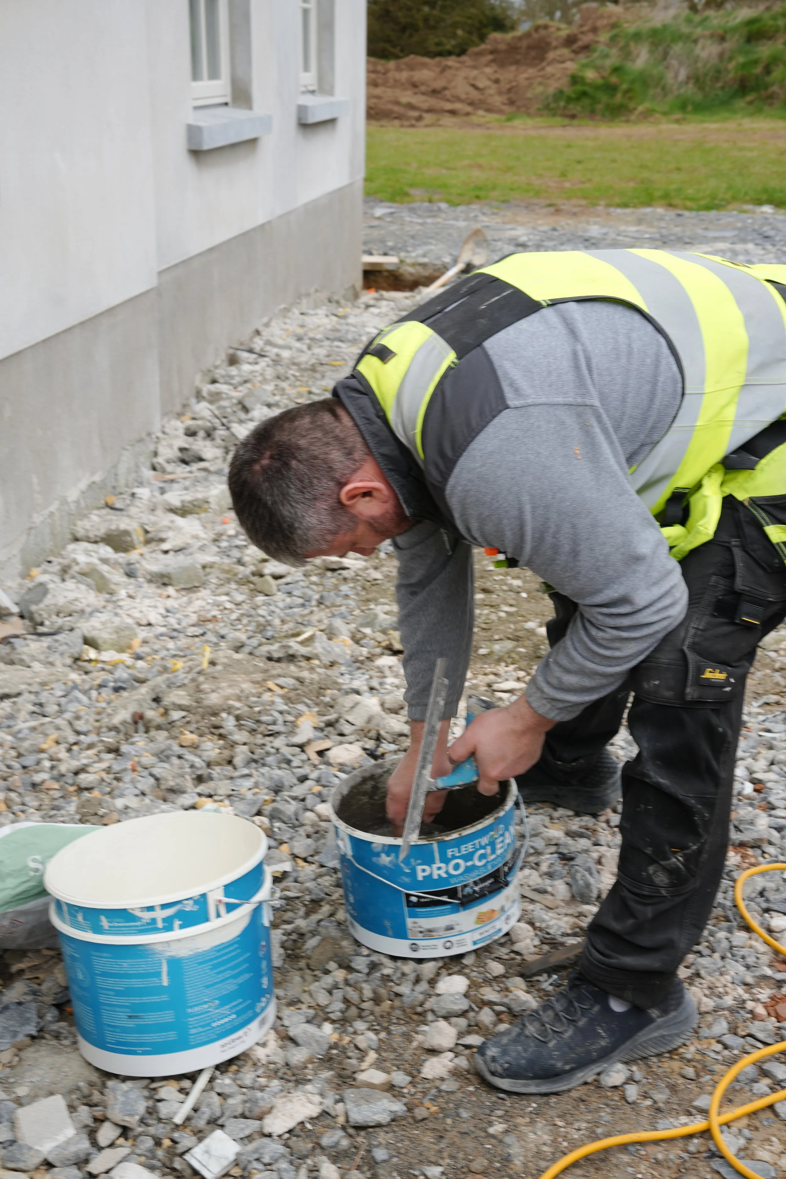 MikeConn team member mixing cement