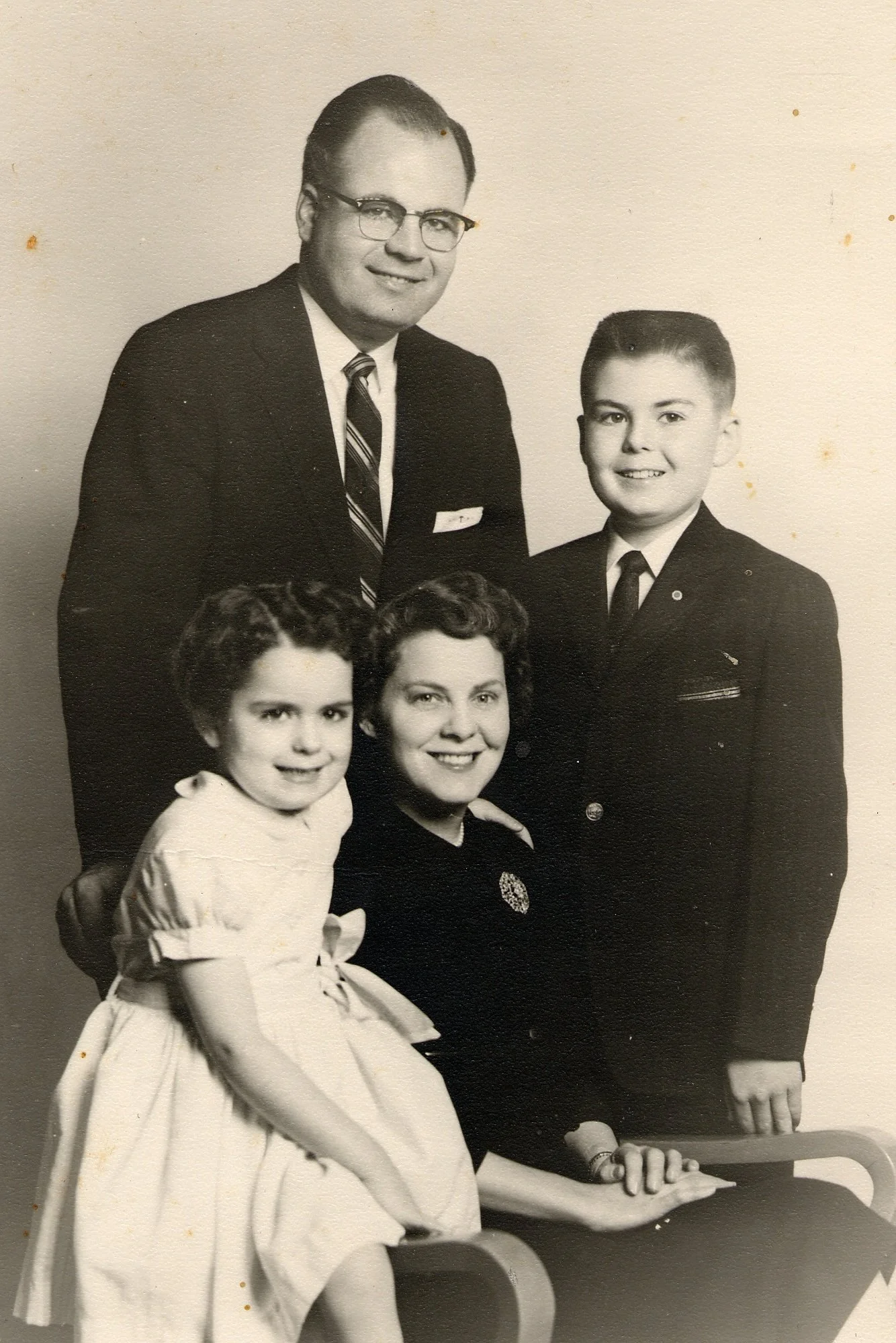 Black and white family portrait of a man, woman, and two children.
