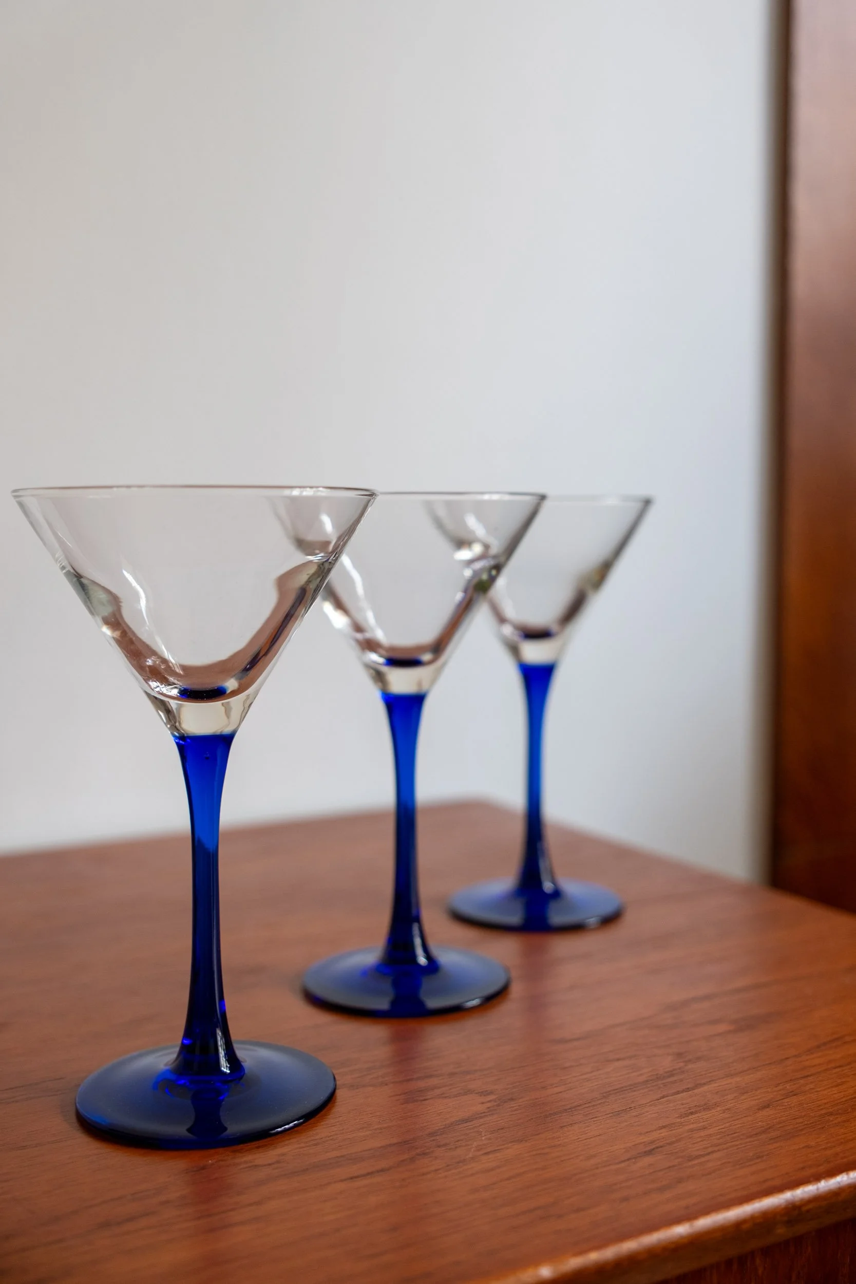 zoom sur trois verres à cocktail au pied bleu alliant élégance et modernité des années 70