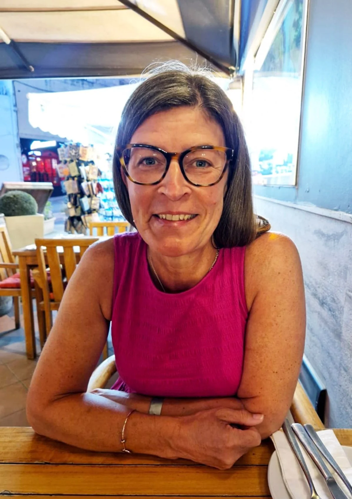 Maria sitting at a table in a restaurant.