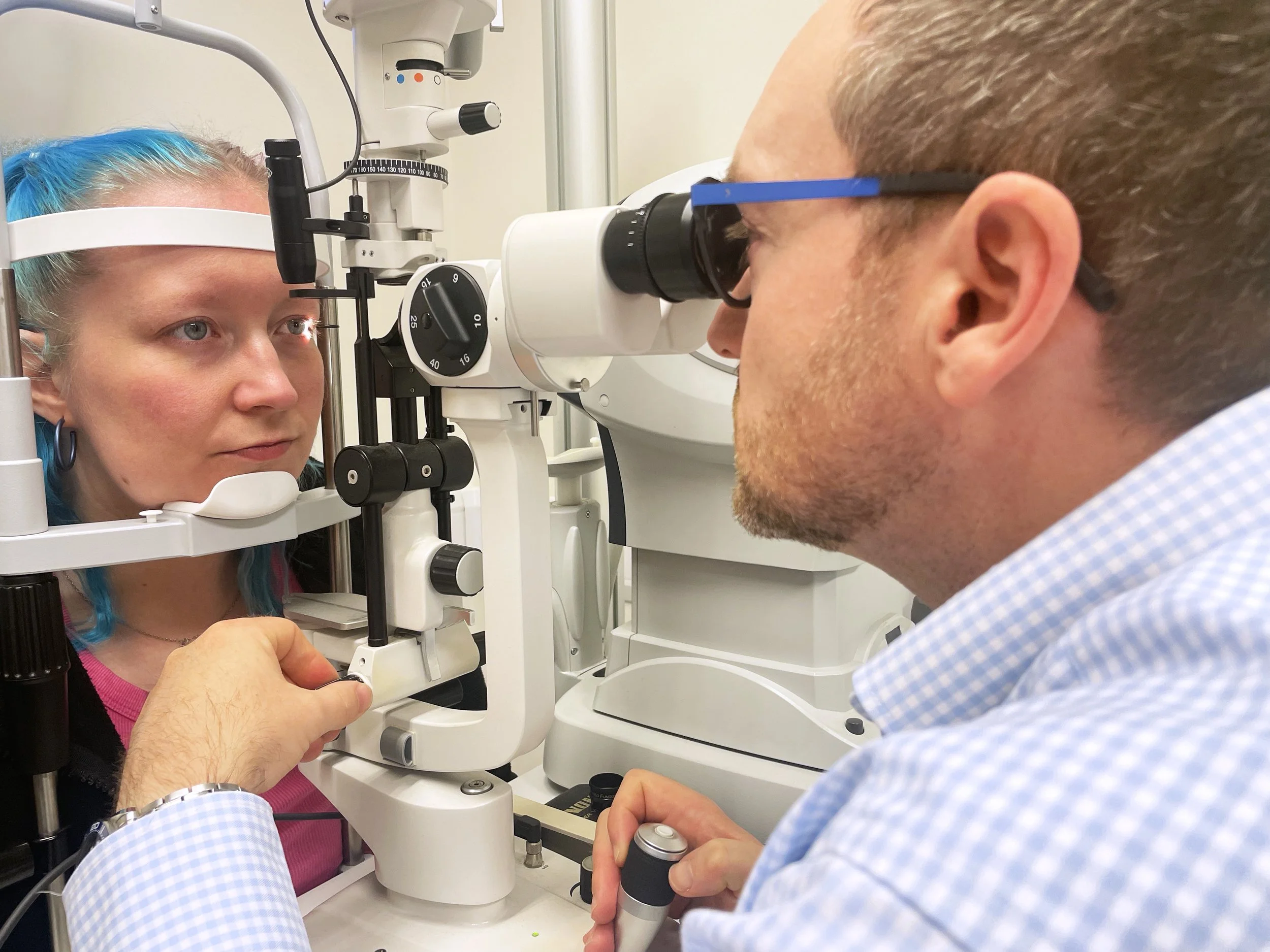 Mark Holloway examines a patient's eyes in one of the examination rooms.