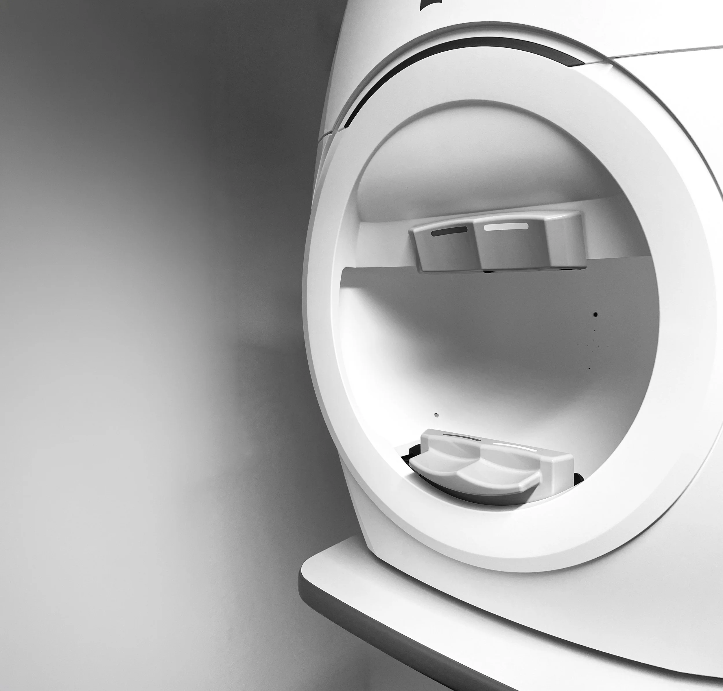Close-up of advanced eye health screening device, set against a plain background.
