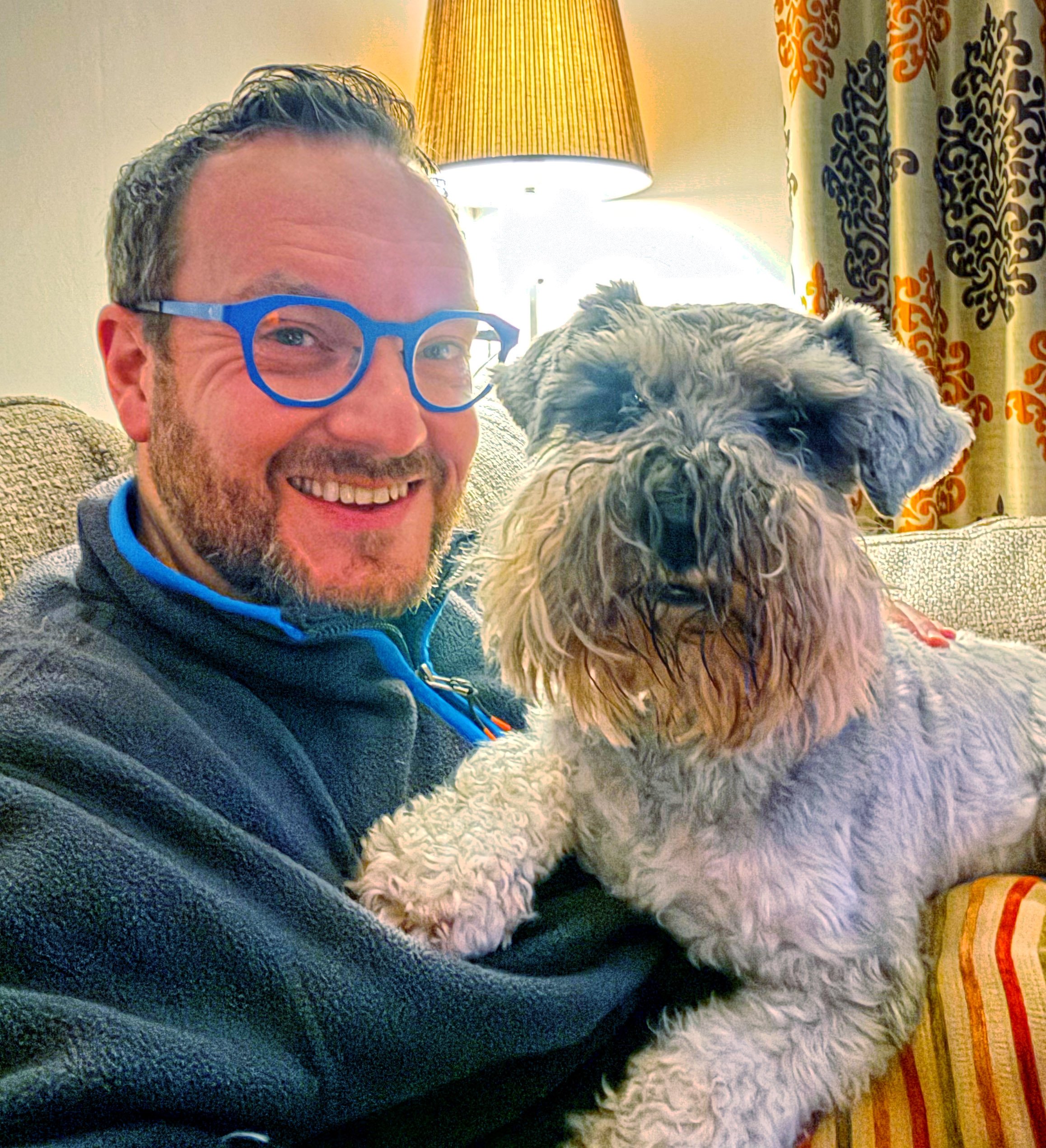 Mark at home with his dog.