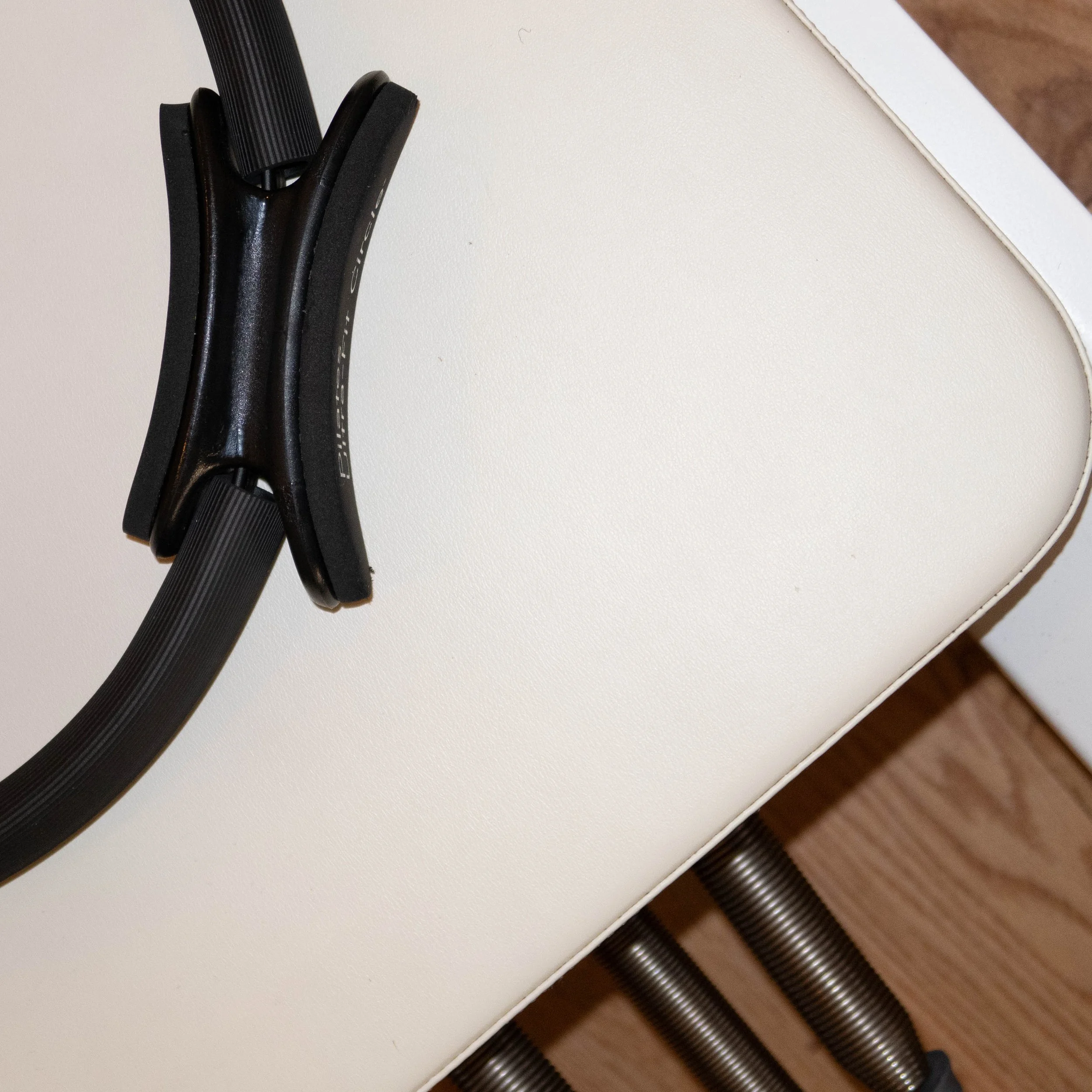 Close-up of a black bicycle helmet on a white table.