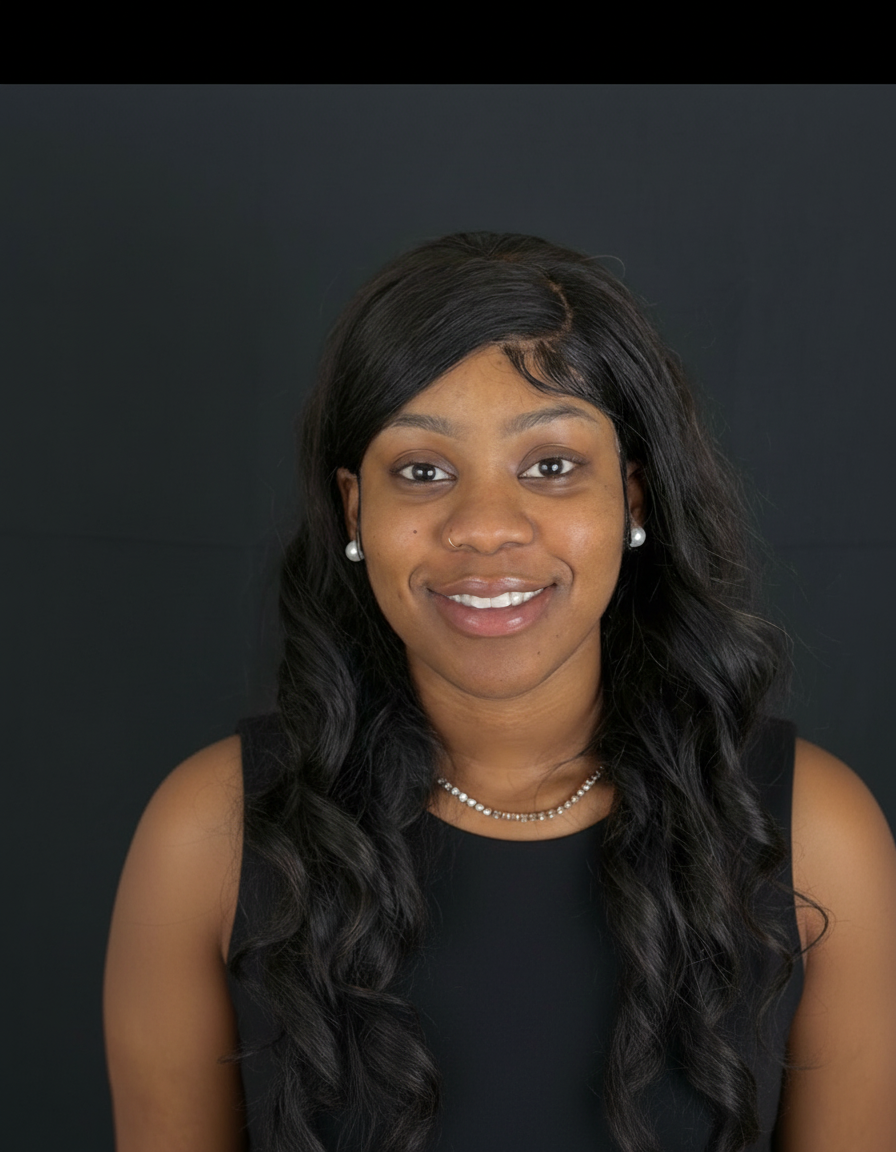 Portrait of a young woman with long black curly hair, wearing pearl earrings, a necklace, and a sleeveless black top, smiling against a black background.