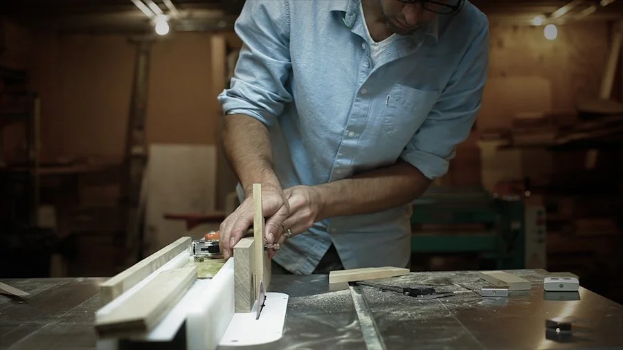 Person working on table saw cutting wood