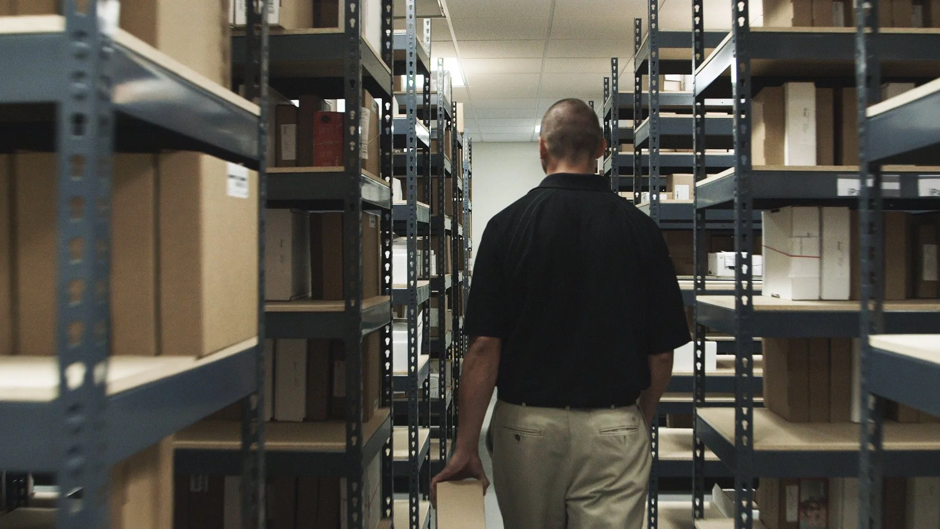 Someone walking through electronics warehouse